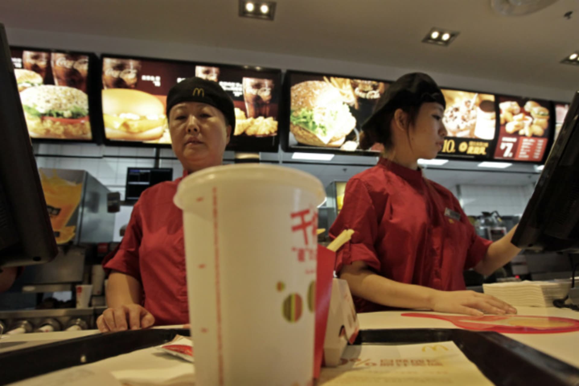 <p>Employees at a McDonald’s Restaurant in Beijing serve food to customers in October 2011 (Stringer/Courtesy Reuters).</p>
