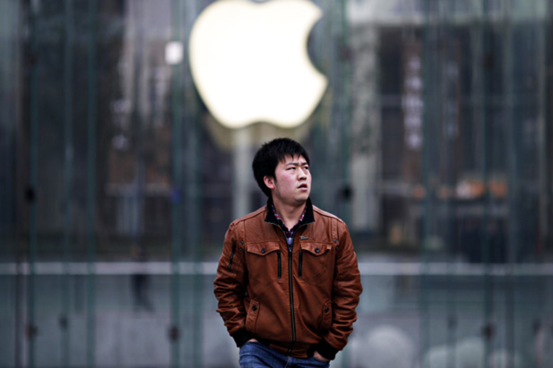 A man walks past an Apple store in Pudong, the financial district of Shanghai, February 29, 2012.  (Carlos Barria / Courtesy Reuters)