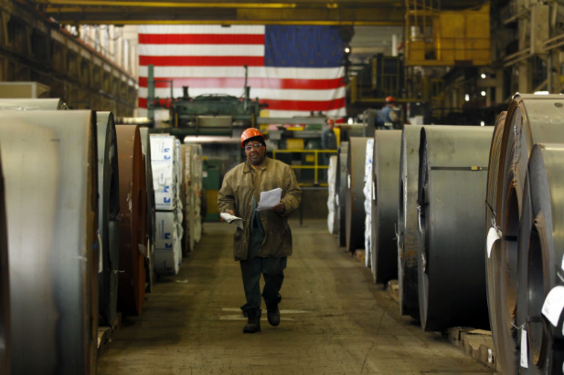 <p>A Gregory Industries employee walks between rolls of steel before a Canton campaign event for Republican presidential candidate Mitt Romney (Brian Snyder/Courtesy Reuters).</p>
