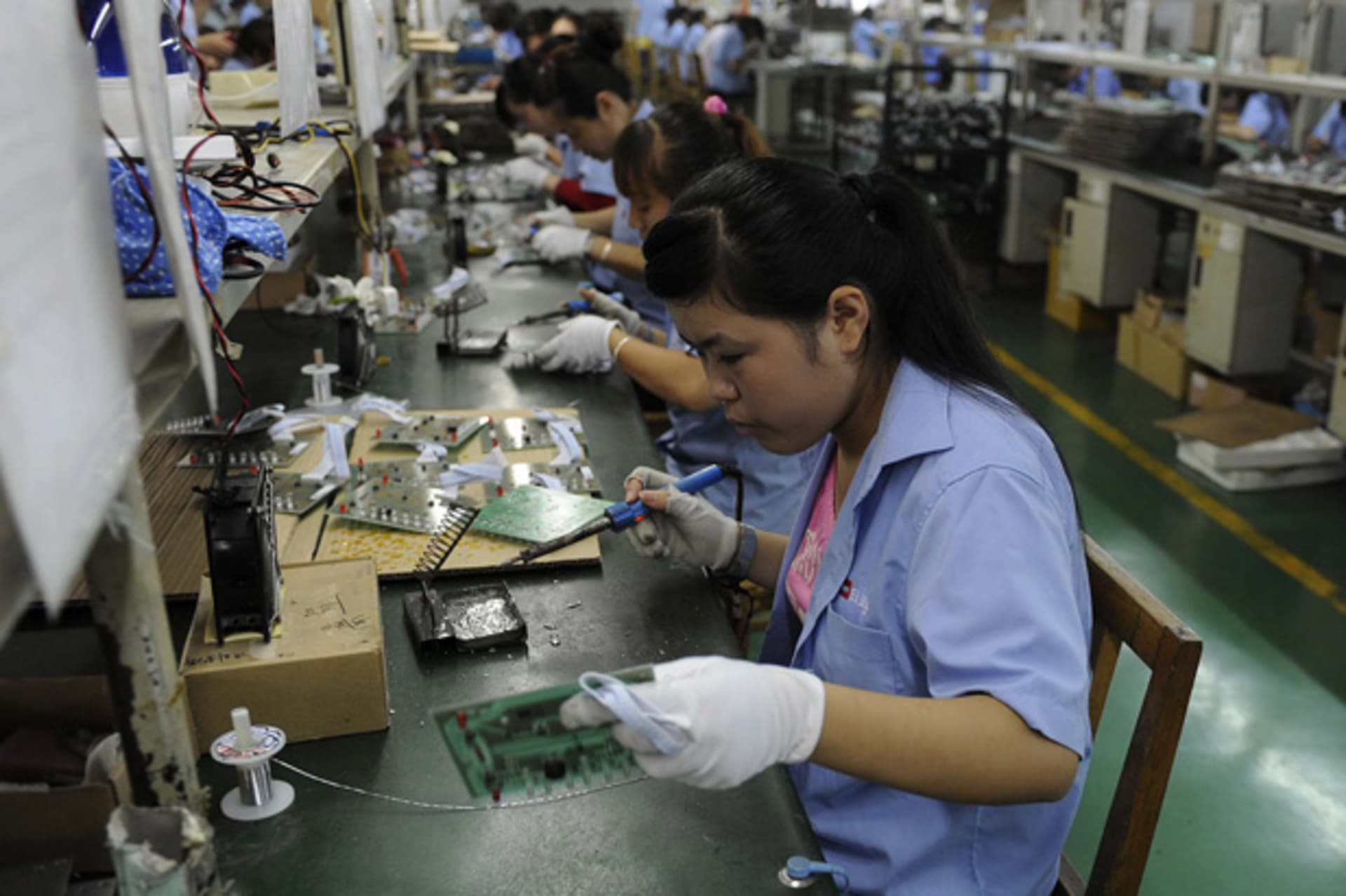 <p>An employee works on circuit boards at an electronic component factory in Hefei,China (Stringer/Courtesy Reuters).</p>
