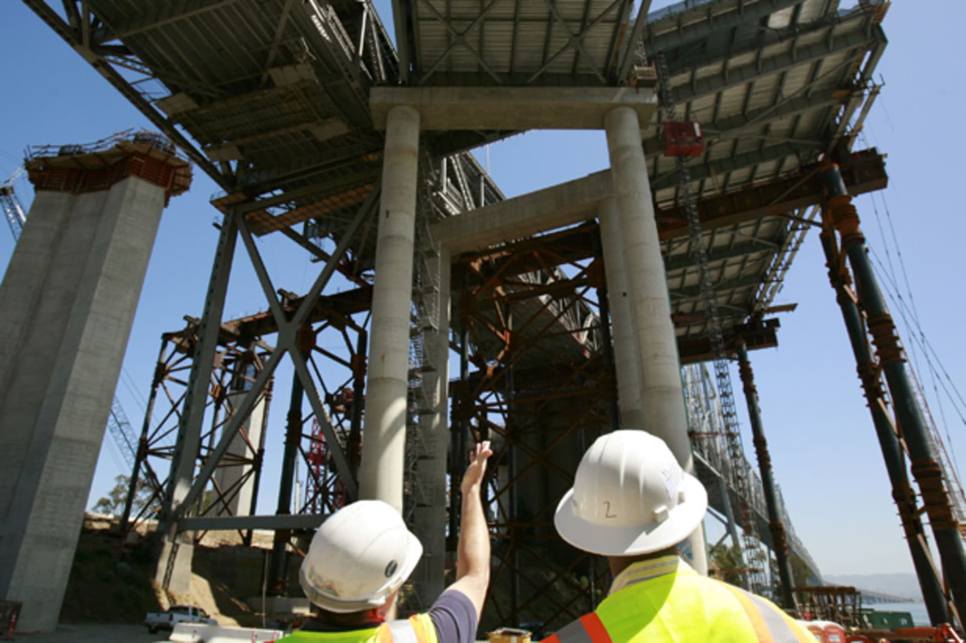<p>A worker displays a new section of roadway on the San Francisco Bay Bridge (Robert Galbraith/Courtesy Reuters).</p>
