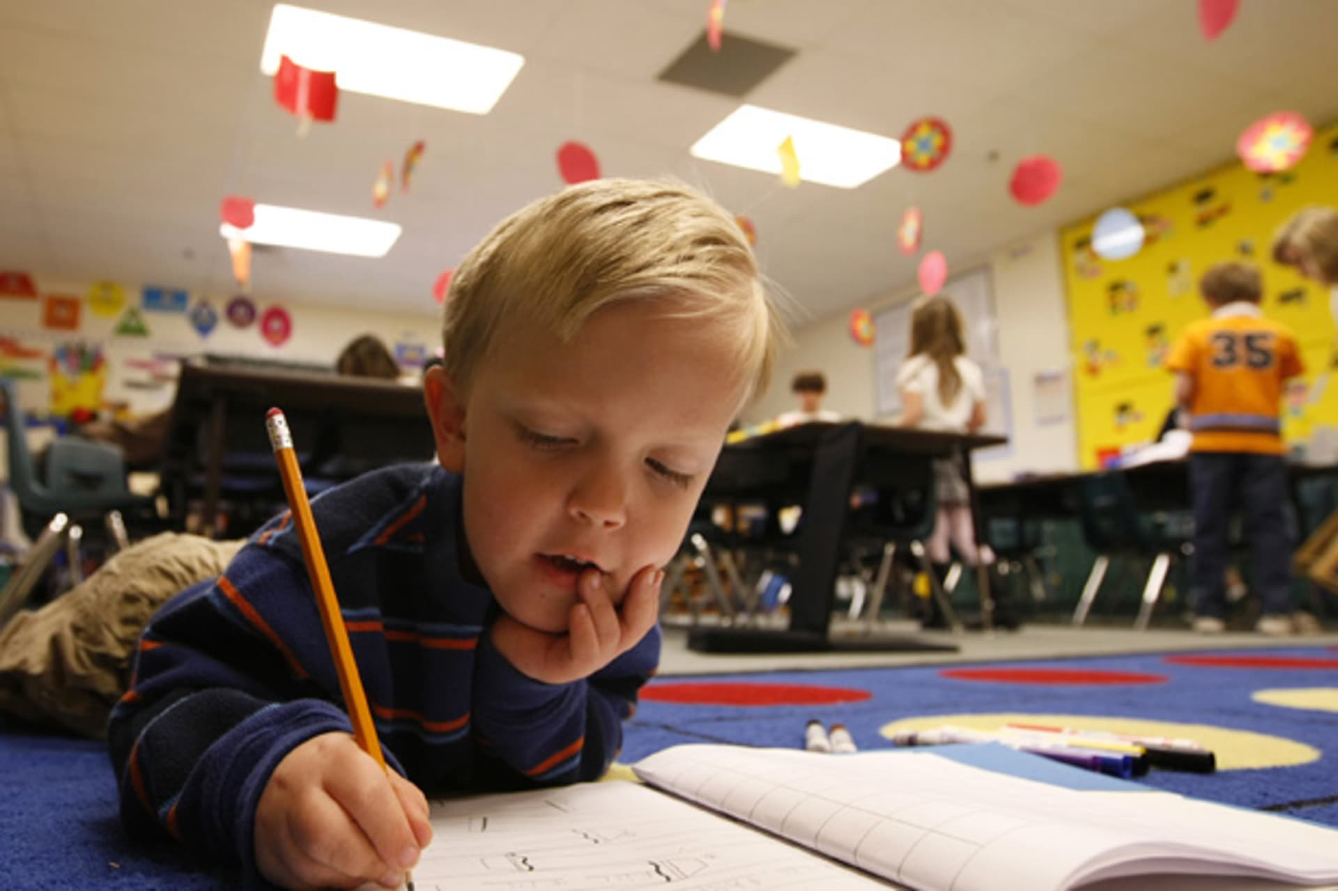 <p>A first grader does his writing work on the floor of a classroom at an elementary school in Thornton, Colorado (Rick Wilking/Courtesy Reuters).</p>
