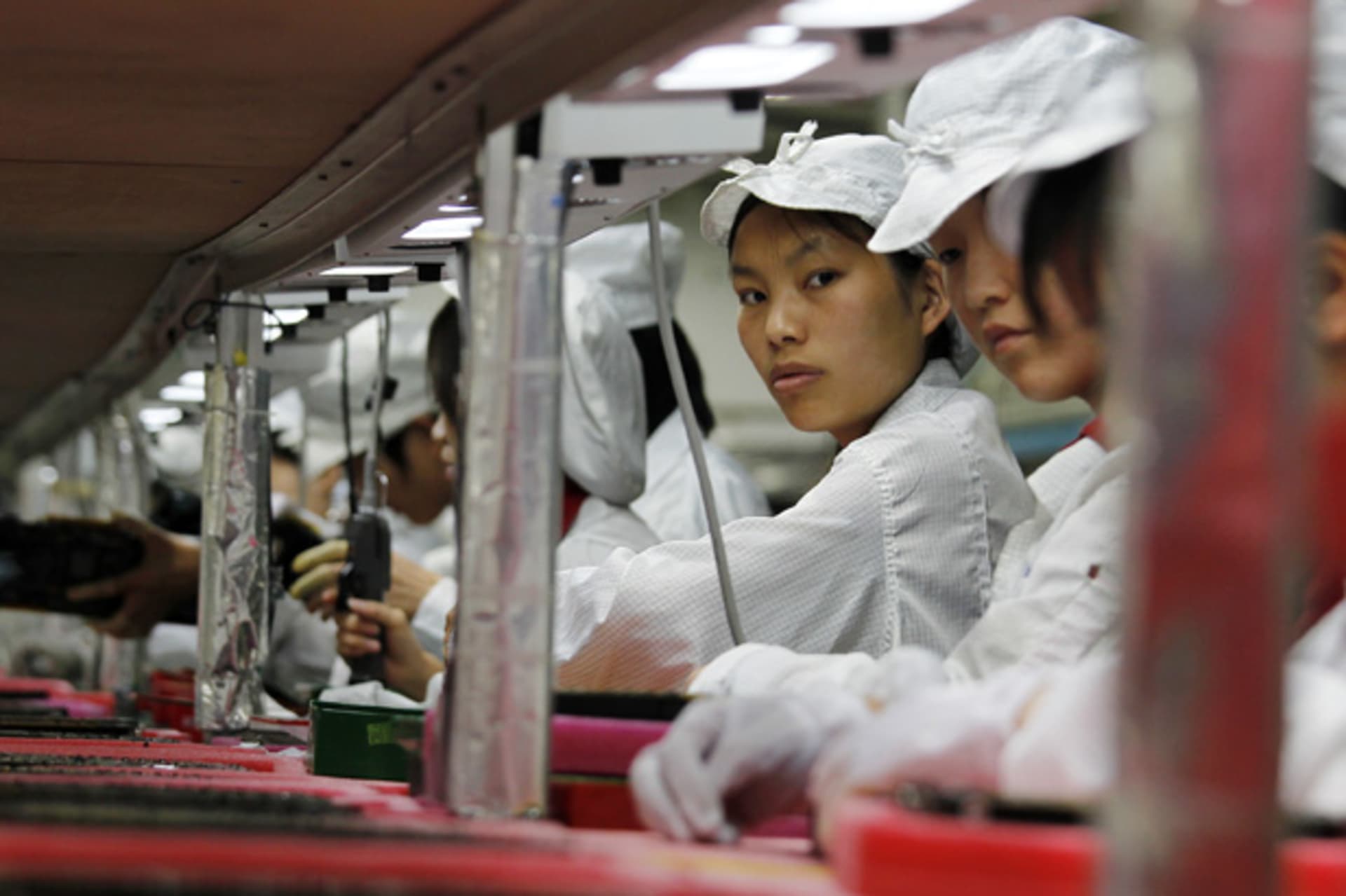 <p>Workers are seen inside a Foxconn factory in the southern Guangdong province of China (Bobby Yip/Courtesy Reuters).</p>
