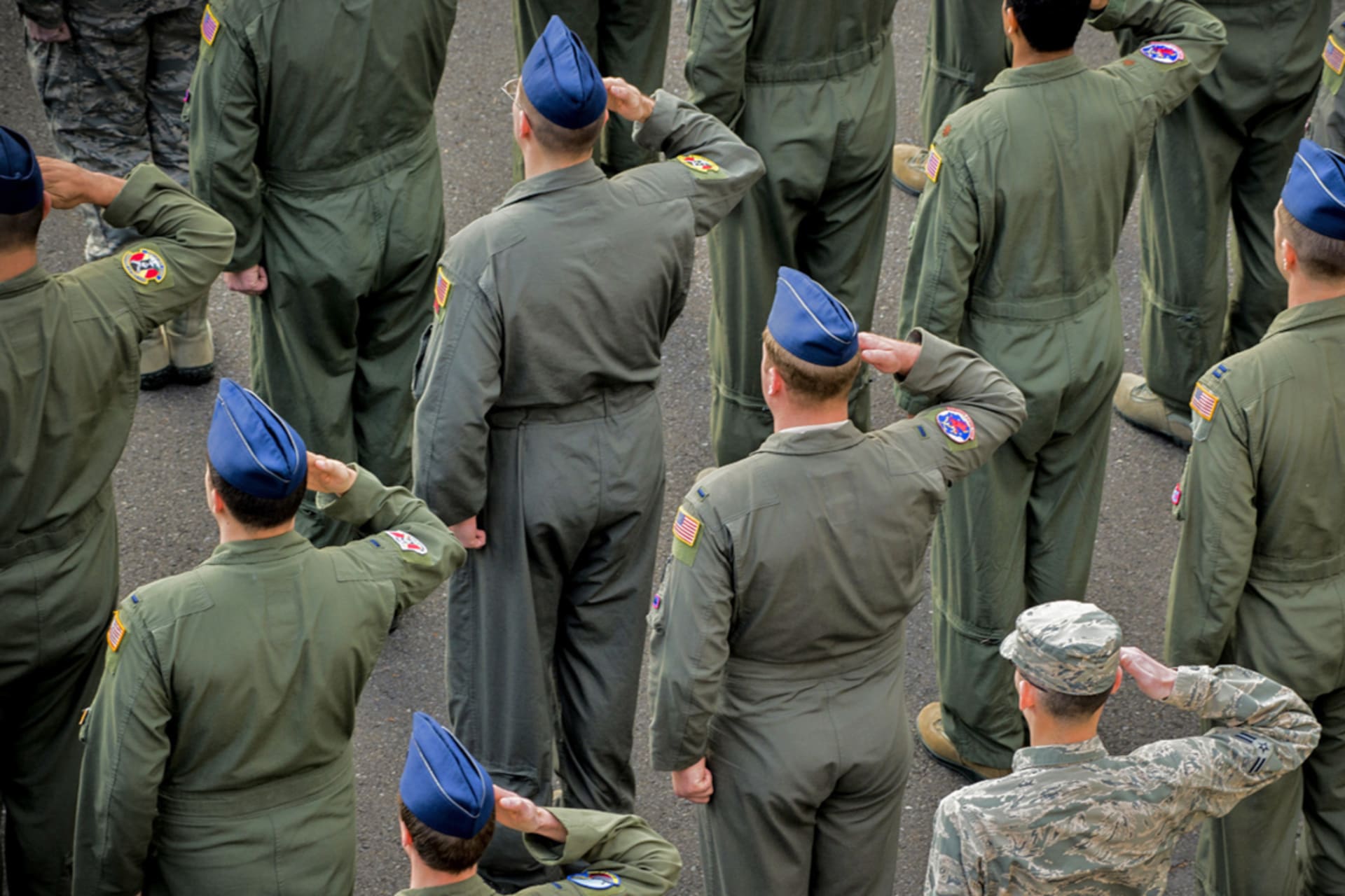 <p>Members of the U.S. Air Force salute during a ceremony at Yokota Air Base, Japan. </p>