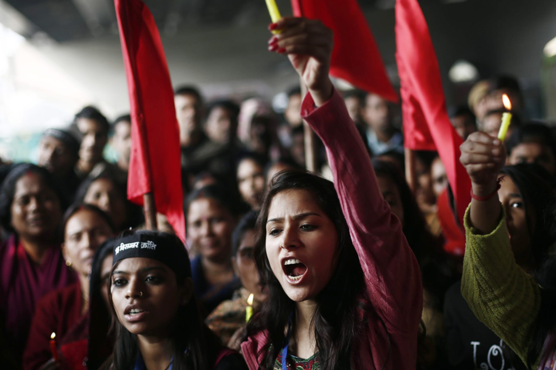 <p>Protesters carry candles as they shout slogans during a demonstration to mark the first anniversary of the Delhi gang rape in New Delhi, India.</p>
