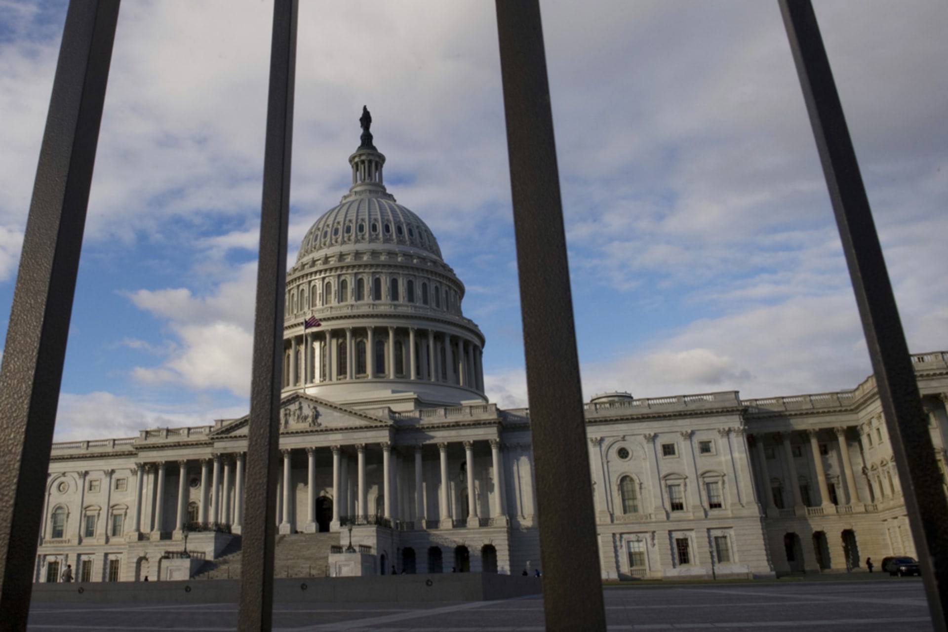 <p>The U.S. Capitol building in Washington, DC, pictured behind a fence.</p>