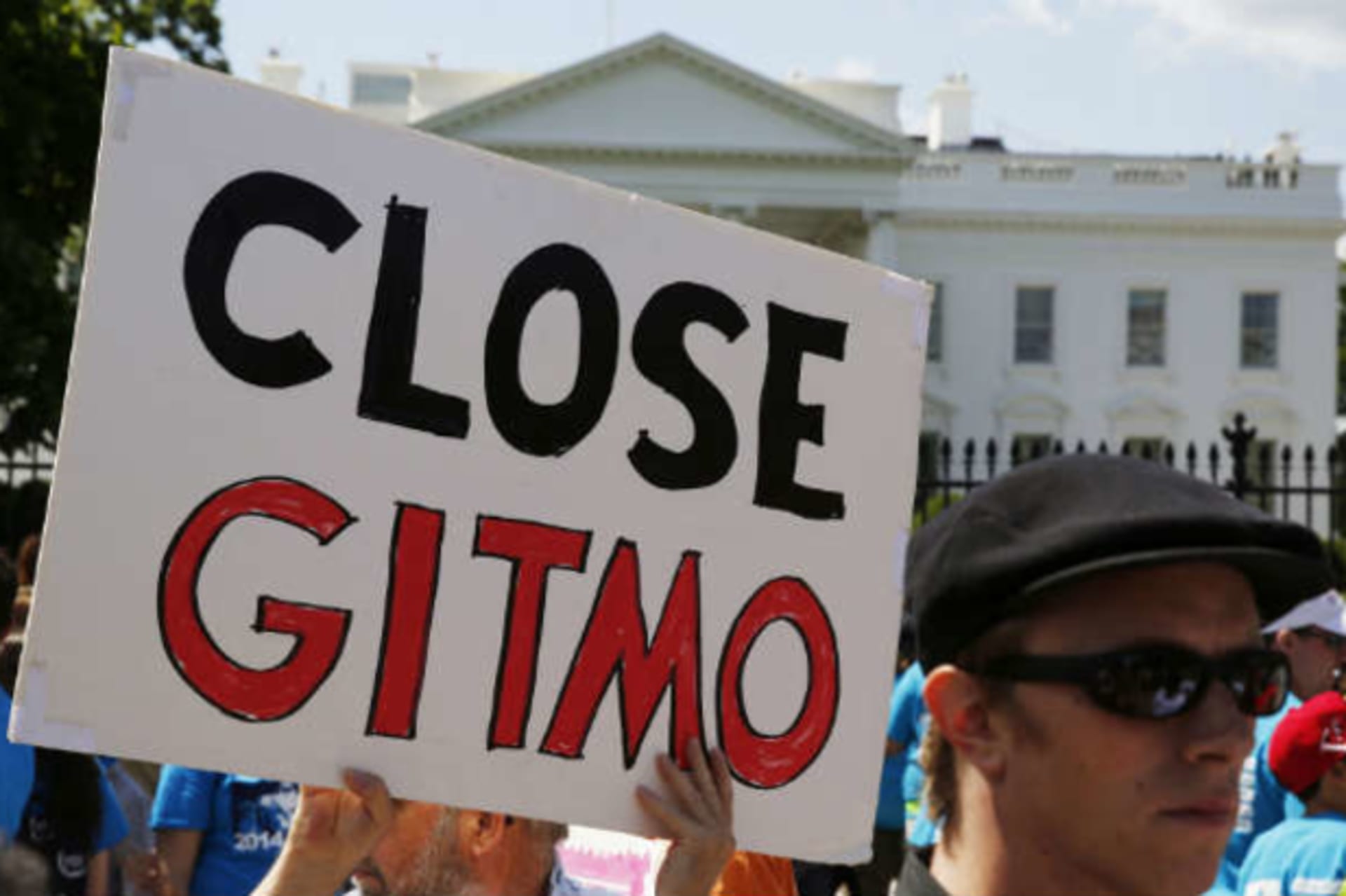 <p>An activist holds a sign at a rally calling for the closure of the Guantanamo Bay prison in Cuba, May 23, 2014. (Larry Downing/Reuters)</p>
