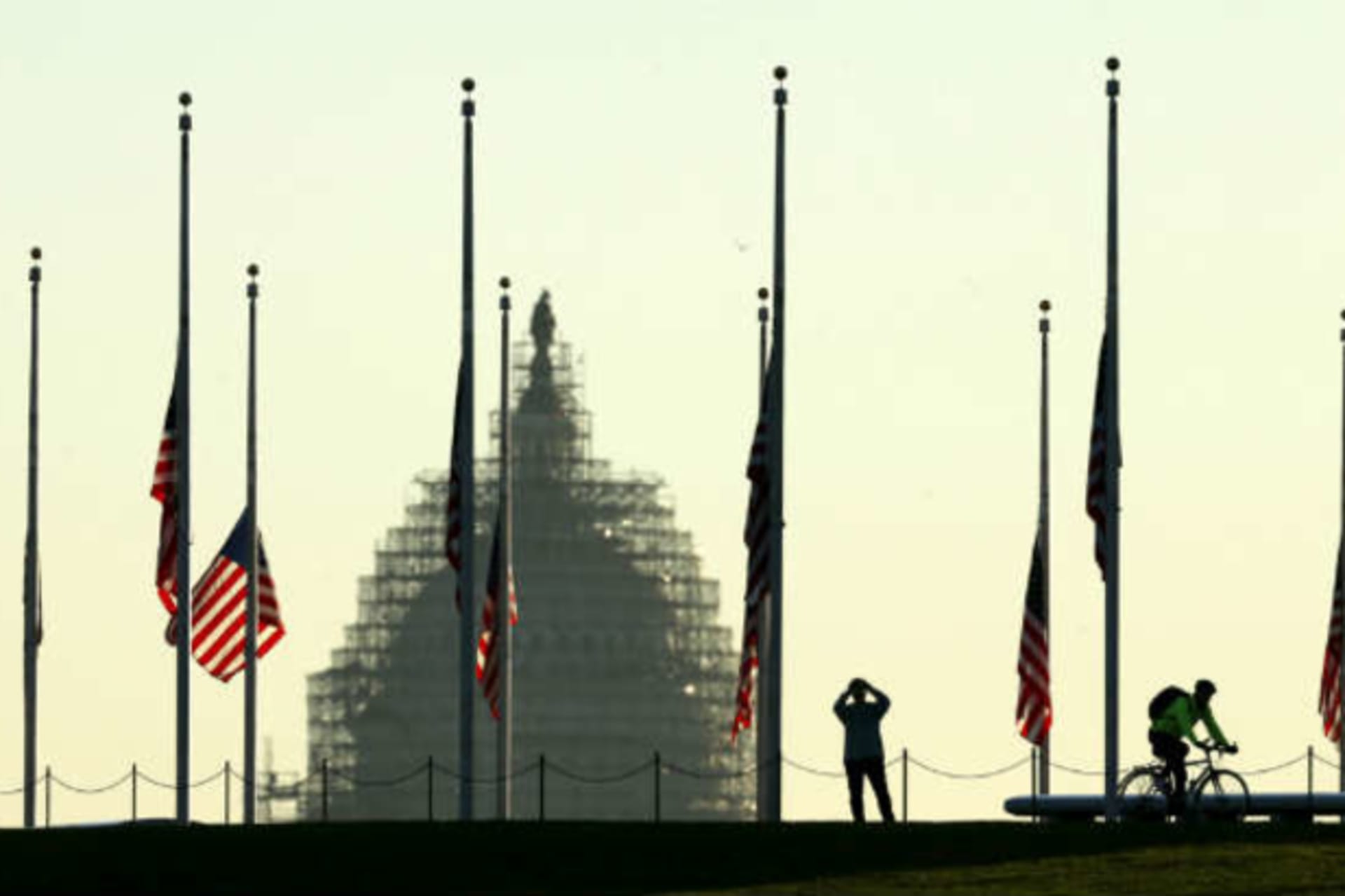 <p>American flags fly at half-staff to honor the victims of the Paris attacks. (Kevin Lamarque/Courtesy Reuters)</p>