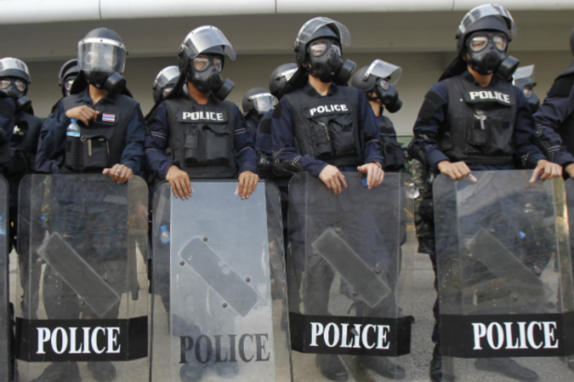 <p>Riot policemen wears gas masks as they stand guard at the Thai-Japan youth stadium in central Bangkok on December 26, 2013. (Chaiwat Subprasom/Courtesy Reuters)</p>
