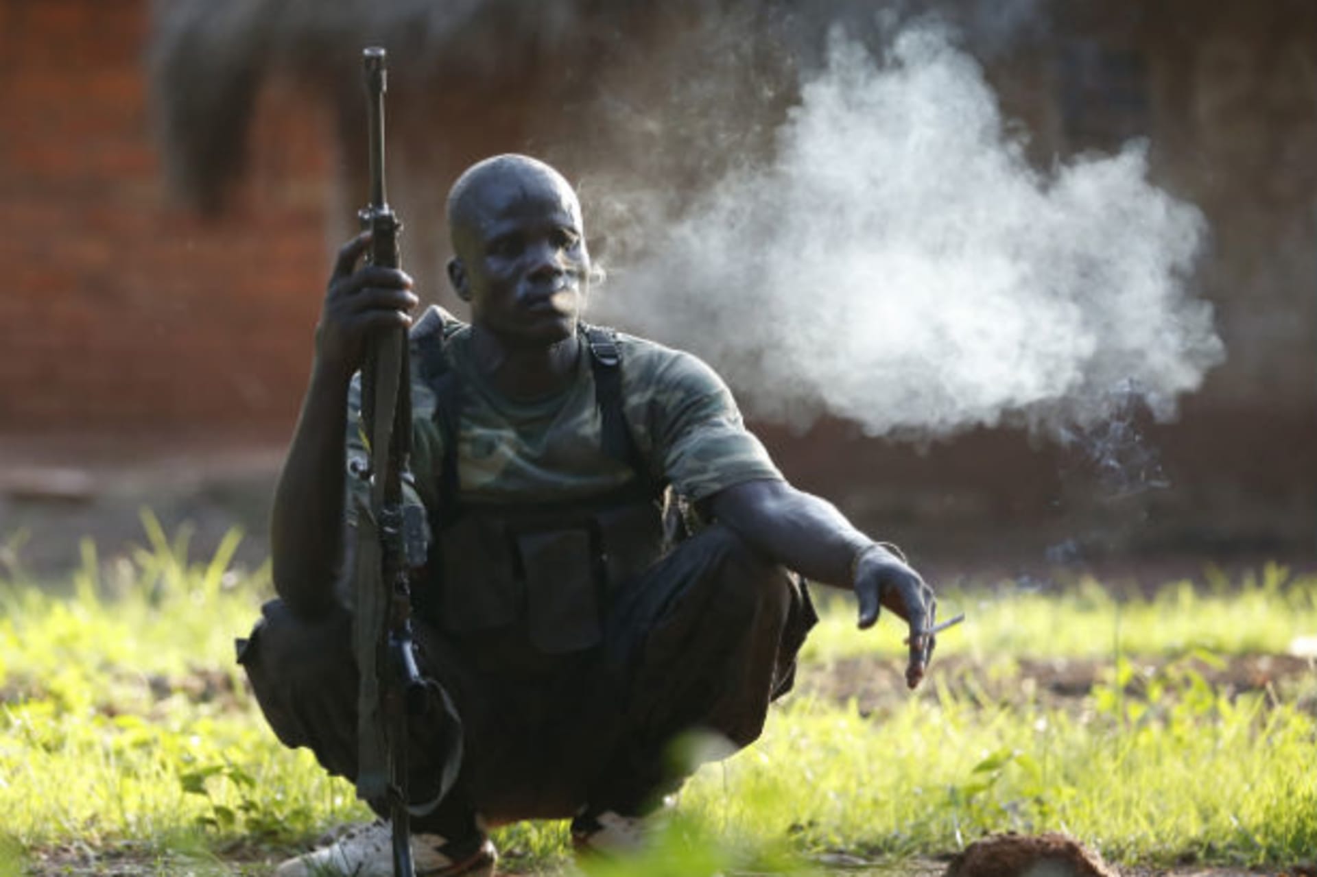 A Seleka fighter takes a break during a patrol as he searches with other Seleka fighters for Anti-Balaka Christian militia members near the town of Lioto June 6, 2014.