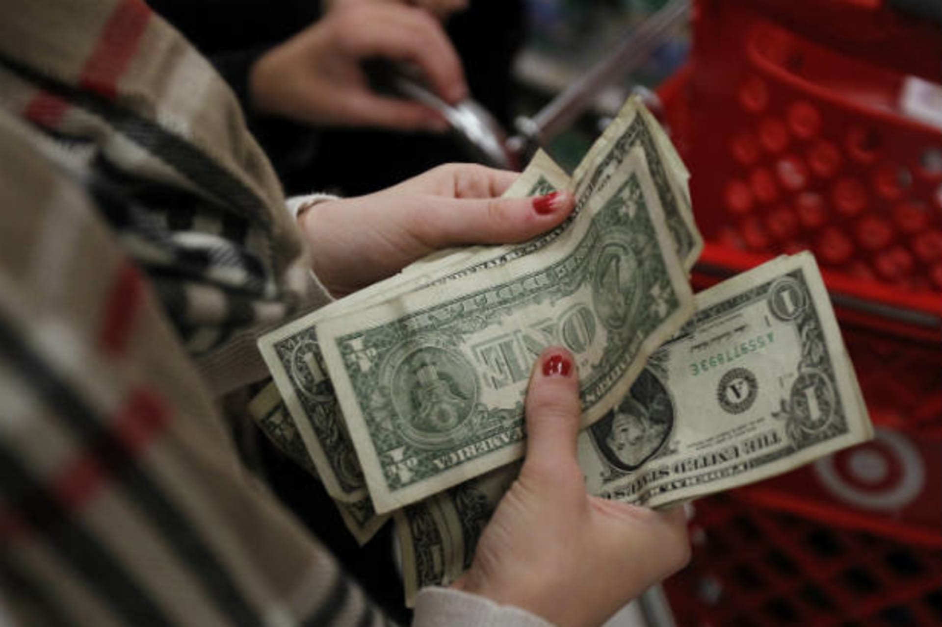 <p>A customer counts her money while waiting in line.</p>
