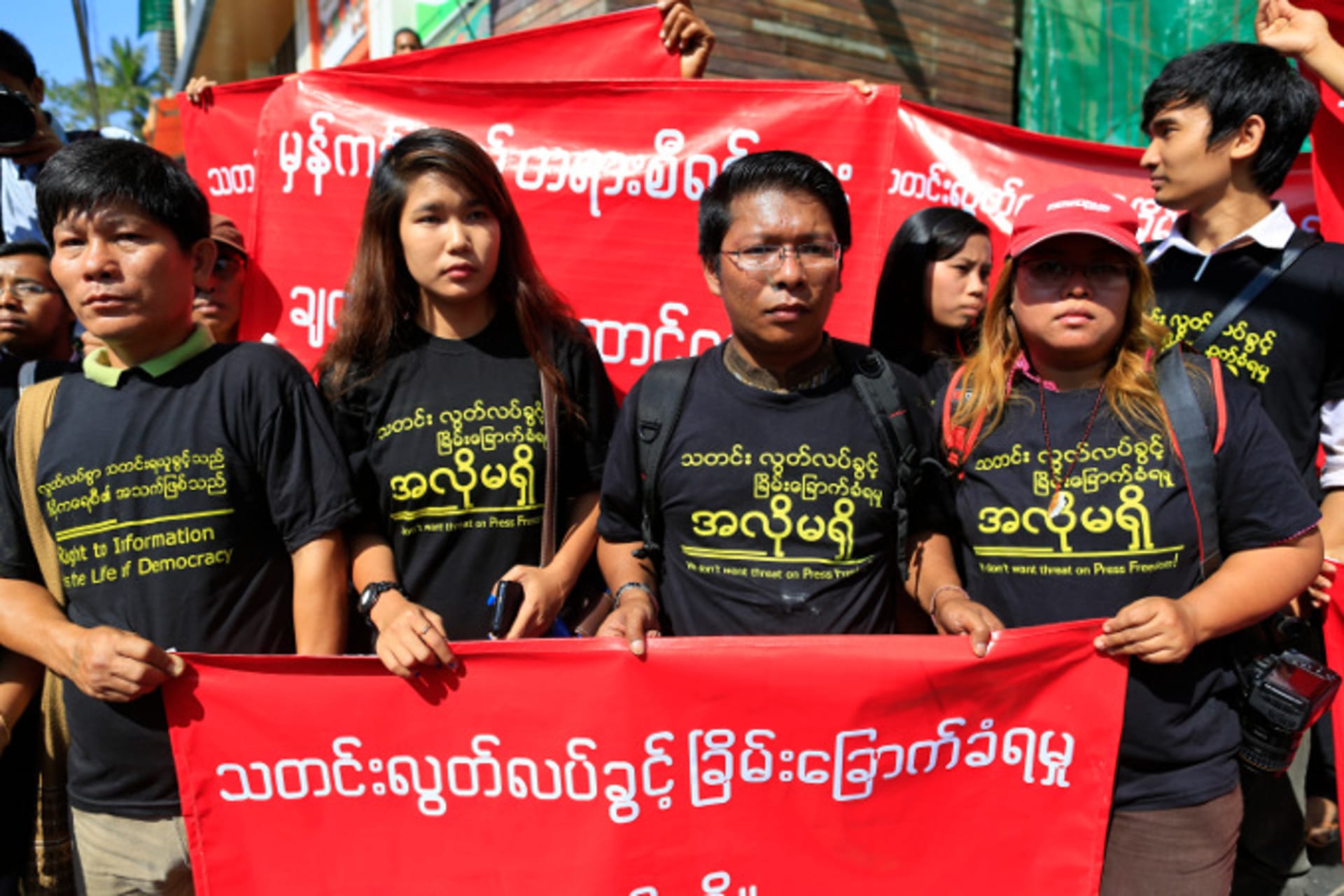 <p>Reporters hold banners as they march for press freedom in Yangon on January 7, 2014. (Soe Zeya Tun/Courtesy Reuters)</p>