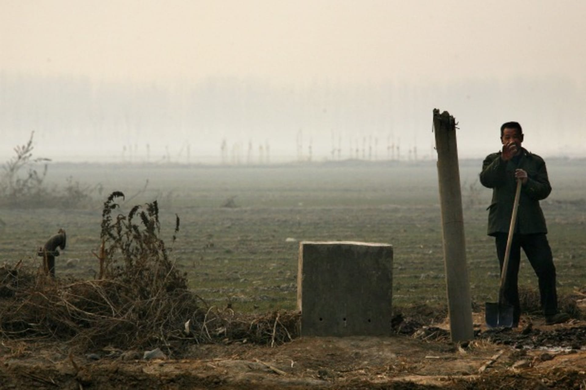 <p>A farmer digs a trench to allow water to irrigate his field planted with winter wheat crop near the village of Lidong, located around 217 miles south of Beijing.</p>
