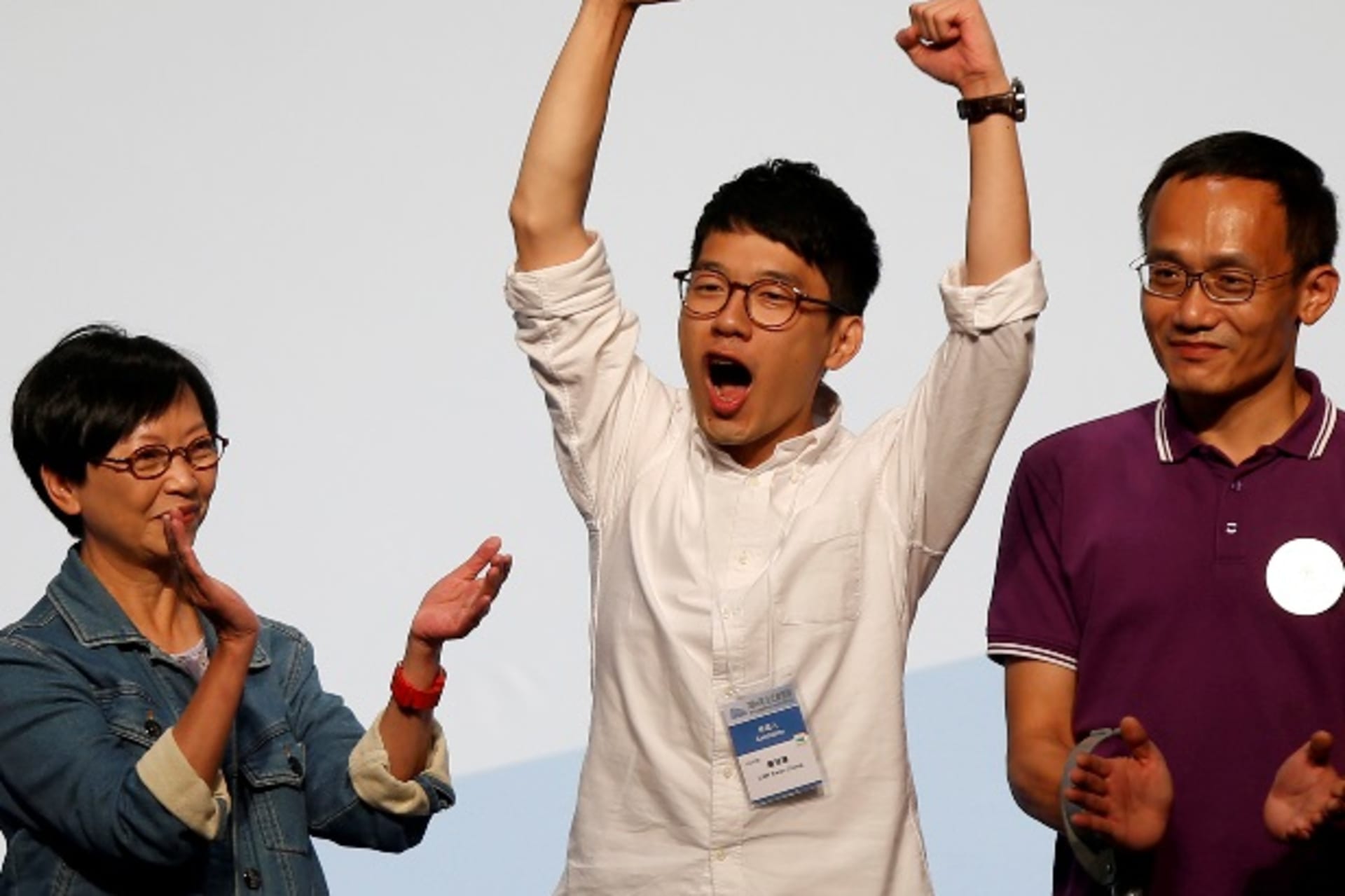 <p>Student leader Nathan Law (C) celebrates on the podium after his win in the Legislative Council election in Hong Kong, China September 5, 2016. REUTERS/Bobby Yip</p>
