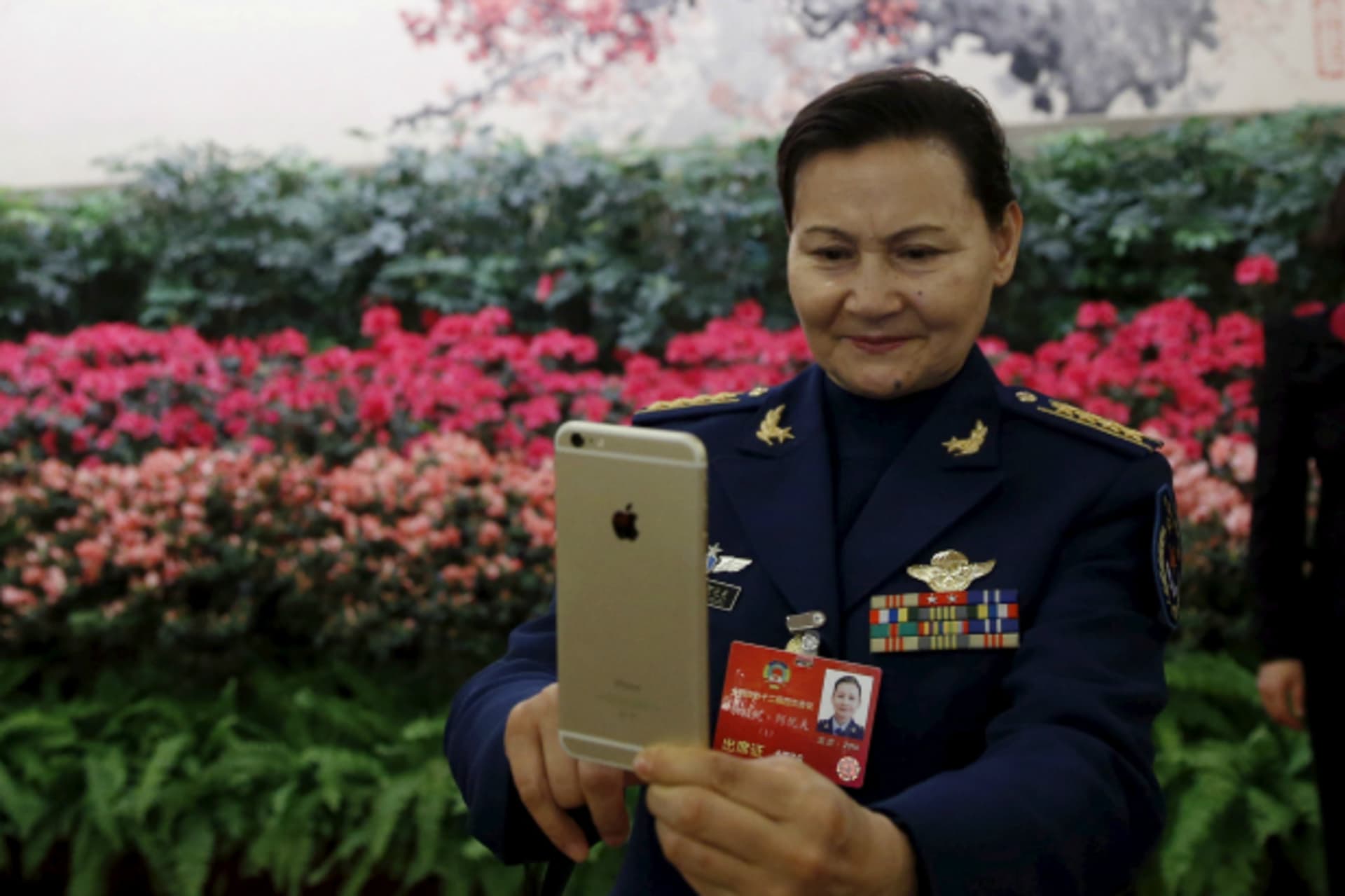 <p>A military delegate takes pictures with her iPhone ahead of the opening session of the Chinese People’s Political Consultative Conference (CPPCC) at the Great Hall of the People in Beijing, China, March 3, 2016. (Kim Kyung-hoon/Reuters)</p>
