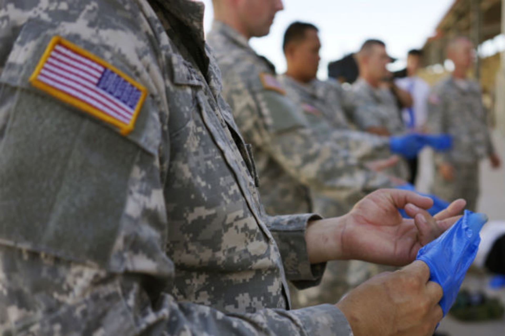 <p>U.S. soldiers practice the proper way to remove protective gloves at Ft. Carson in Colorado Springs, Colorado, on October 23, 2014, prior to their deployment to Africa as part of the U.S. military response to the Ebola crisis.</p>
