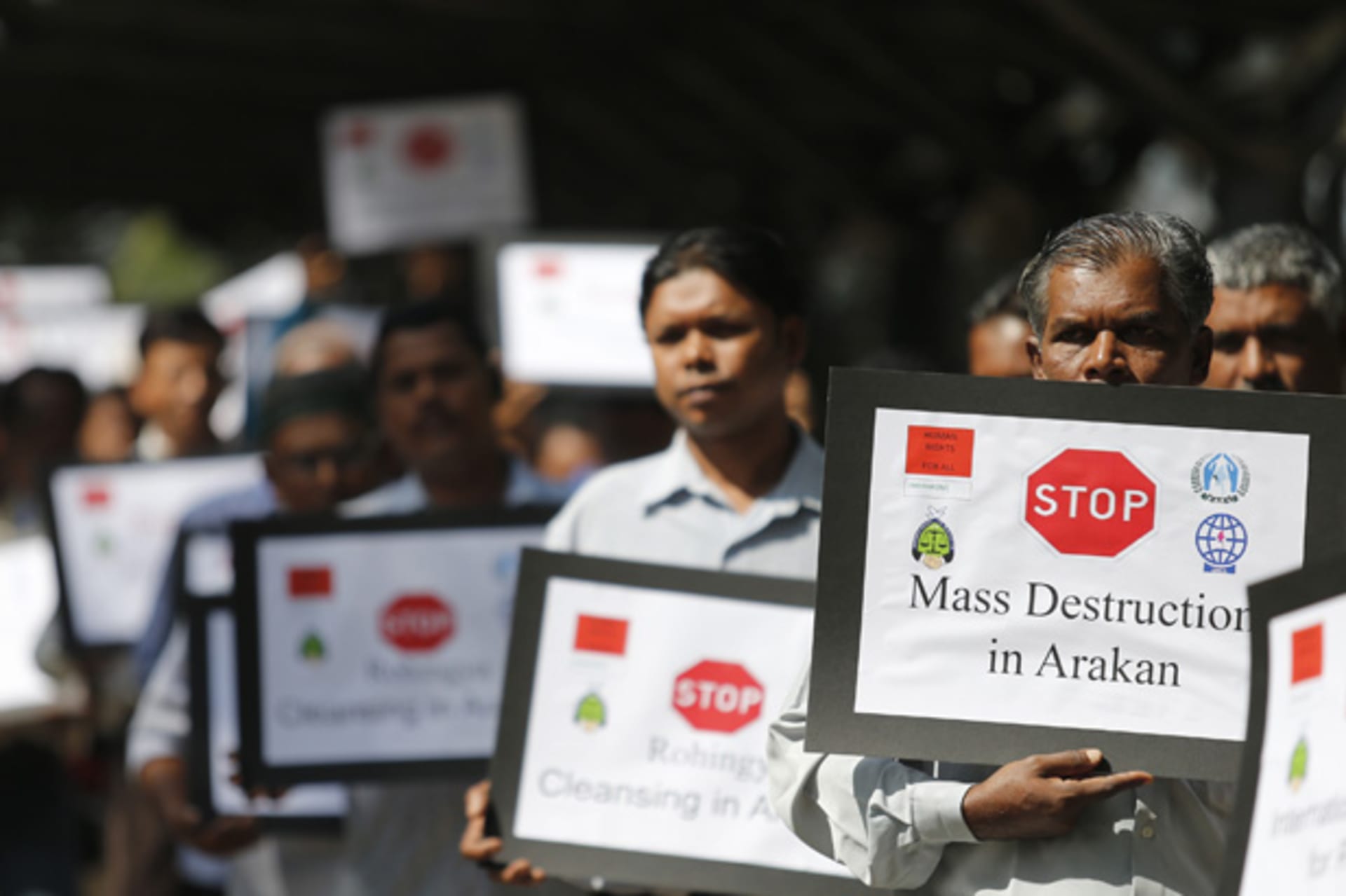 <p>Myanmar people of Rohingya ethnicity who are living in Malaysia, display placards during a rally outside Malaysia’s Foreign Ministry in Putrajaya.</p>
