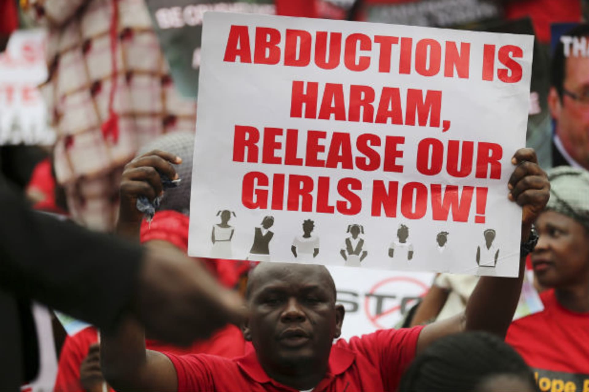 A man holds a placard calling for the release of secondary school girls abducted in the remote village of Chibok, during a protest along a road in Lagos May 14, 2014.