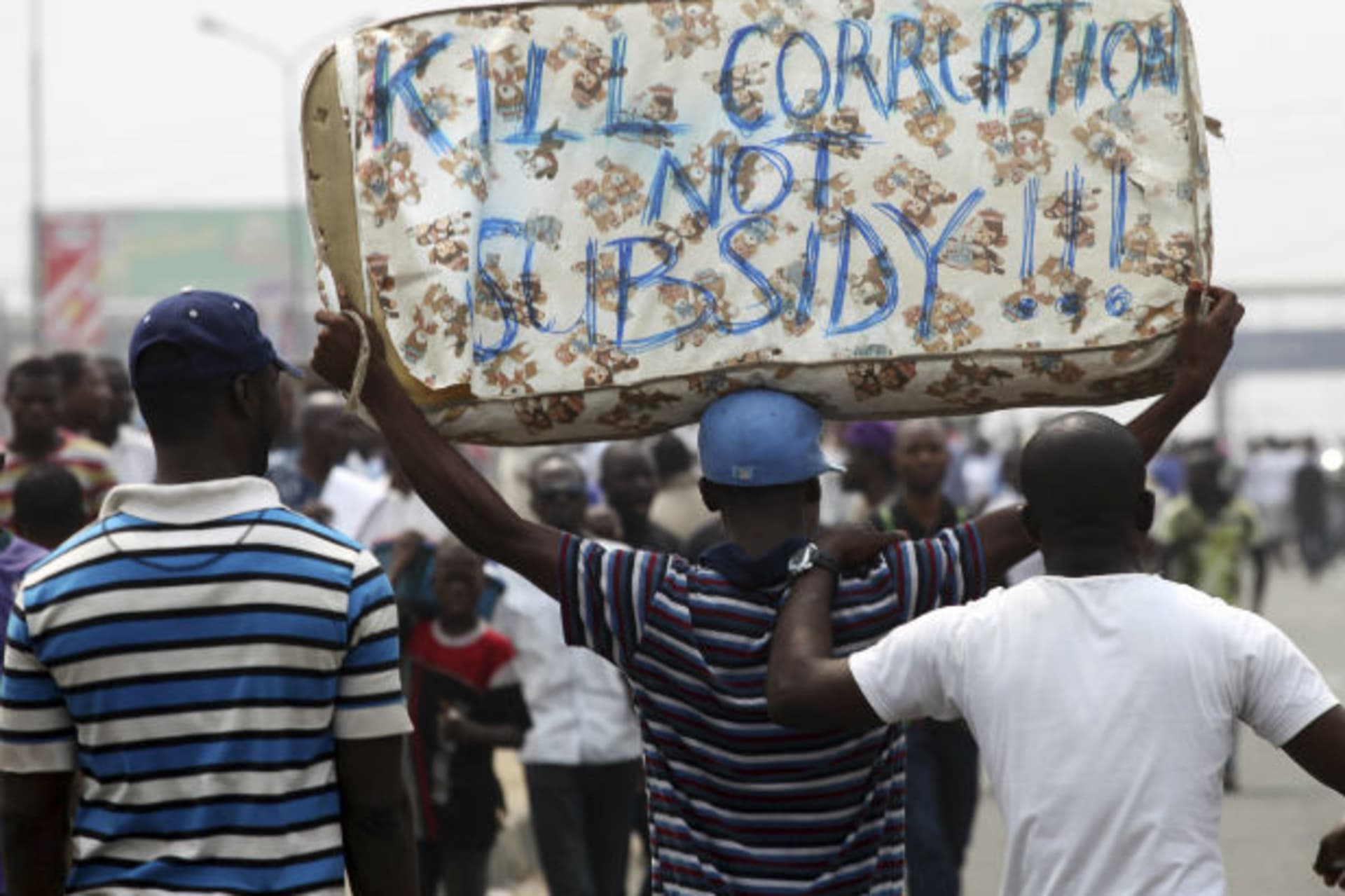 Protesters carry a mattress on the second day of a protest against a removal of fuel subsidies in Lagos 10/01/2012.