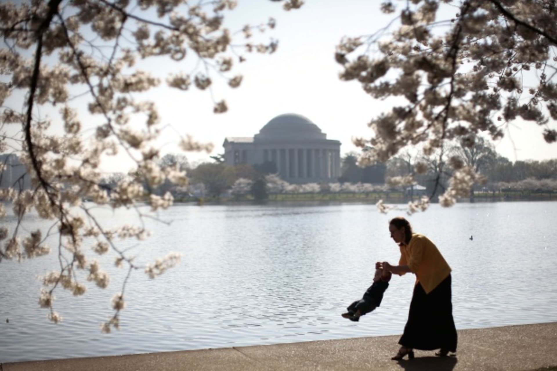 <p>A mother swings her young son while walking along the tidal basin in Washington, DC (Jason Reed/Courtesy Reuters).</p>
