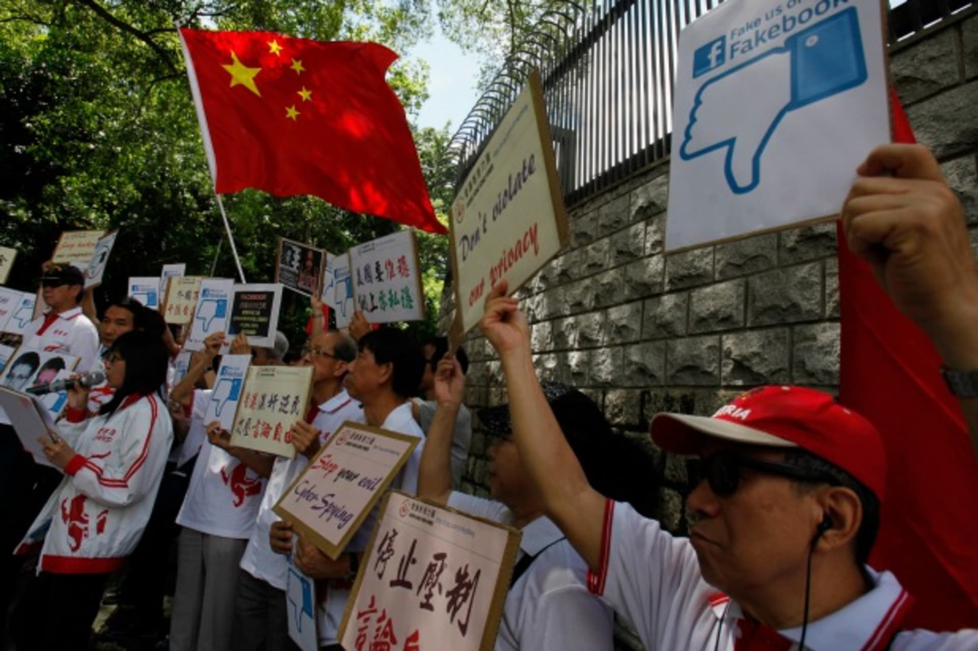 <p>Demonstrators from the pro-China “Caring Hong Kong Power” group protest over claims from former U.S. spy agency contractor Edw…cked computers in the Chinese territory, outside the U.S. Consulate in Hong Kong on July 9, 2013. (Bobby Yip/Courtesy Reuters)</p>
