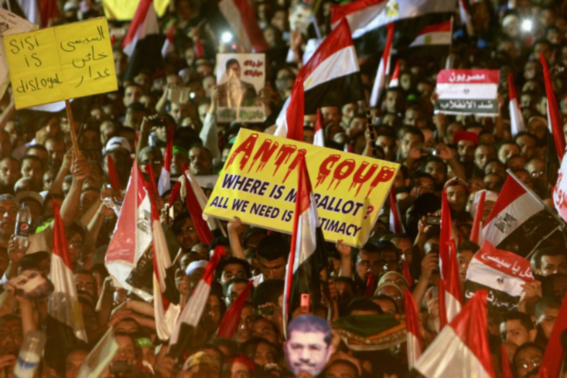 <p>Members of the Muslim Brotherhood and supporters of deposed Egyptian President Mohamed Mursi wave Egyptian flags, signs and ma…gather at the Rabaa Adawiya square, where they are camping, in Cairo on July 12, 2013. (Mohamed Abd El Ghany/Courtesy Reuters)</p>
