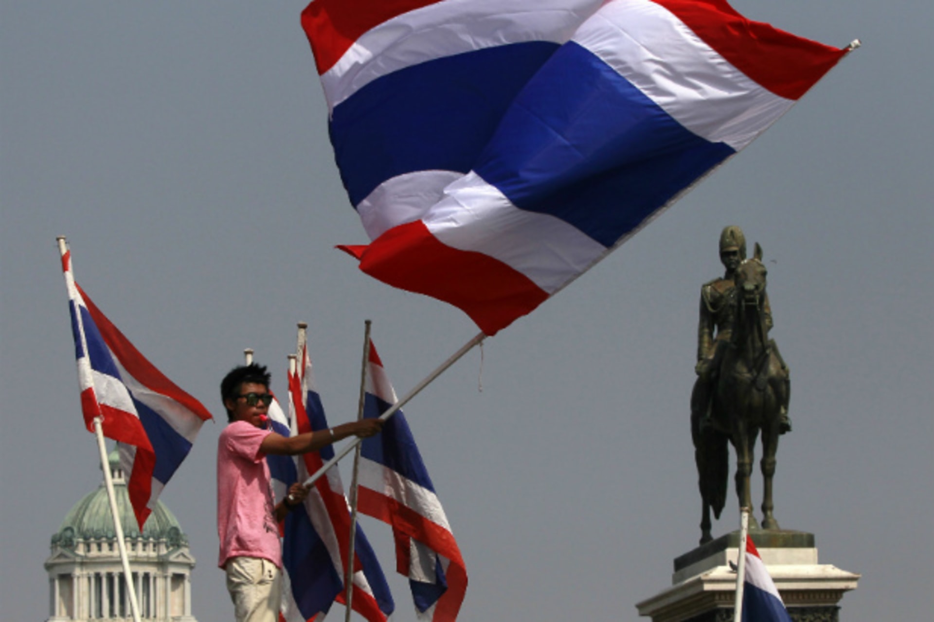 <p>An anti-government protester waves a Thai national flag during a rally at the Royal Plaza near the Government House in Bangkok on December 9, 2013. (Chaiwat Subprasom/Courtesy Reuters)</p>
