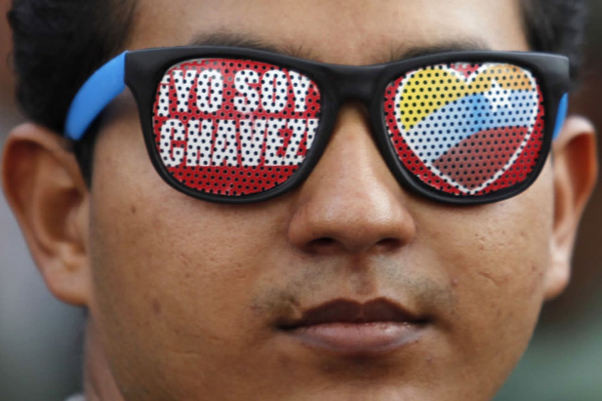<p>A supporter of Venezuela’s President Hugo Chavez wears glasses reading “I’m Chavez” as he attends a parade to commemorate the 21st anniversary of Chavez’s attempted coup d’etat in Caracas February 4, 2013.</p>
