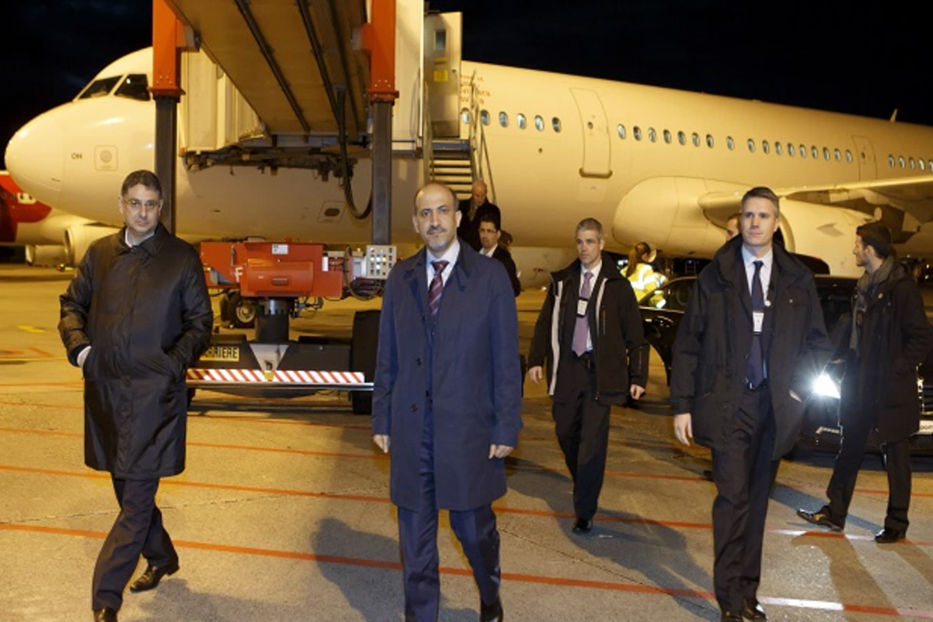 Leader of Syria's opposition National Coalition Ahmad al-Jarba and Badr Jamous, secretary-general of the coalition, arrive for the Geneva 2 talks on Syria, at Geneva International airport