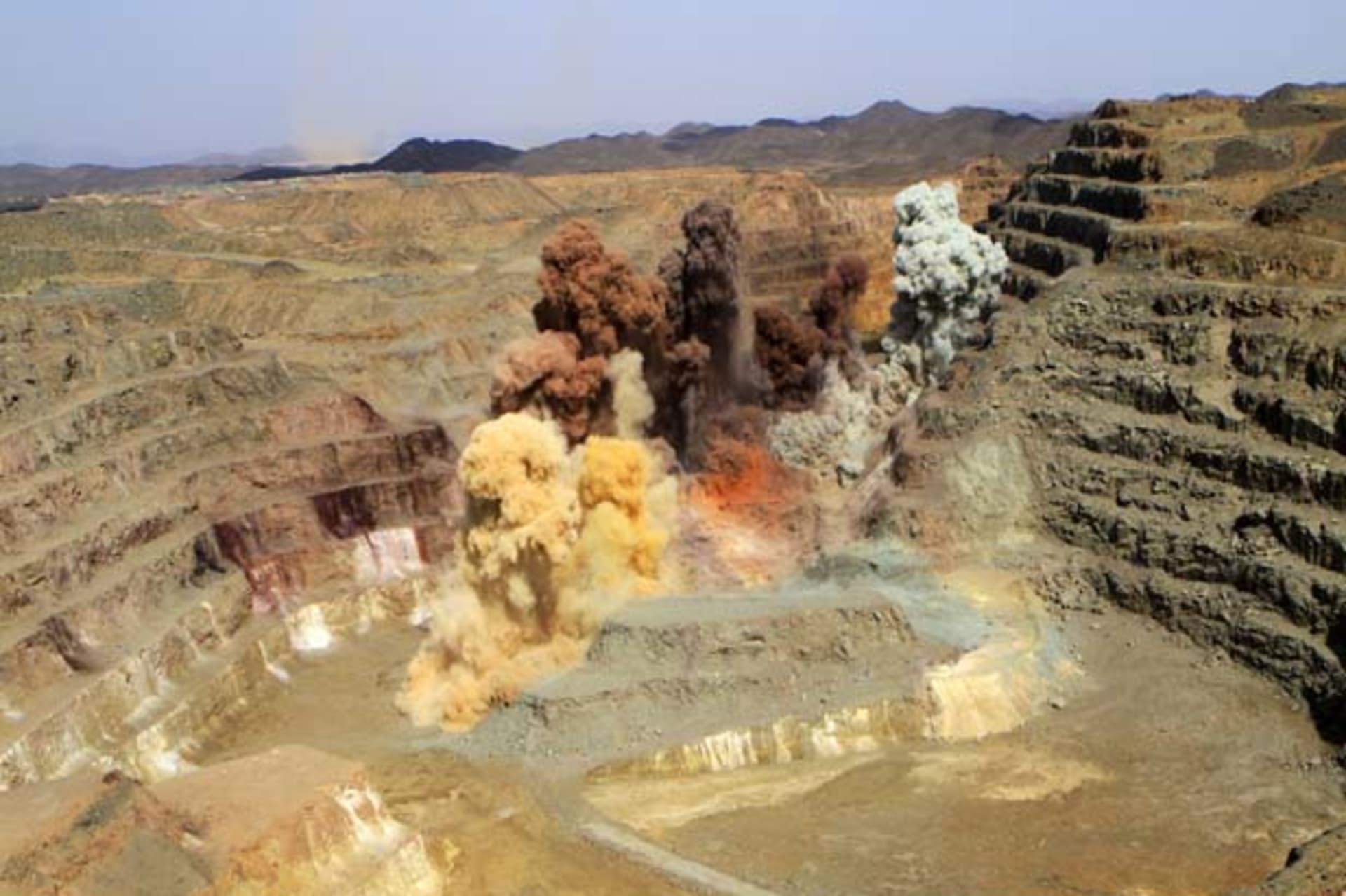 Smoke rises after a blast in a quarry at the Ariab mine