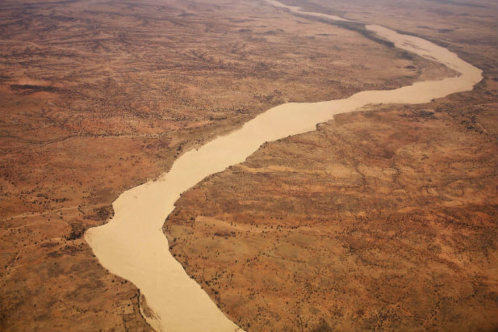 A dried up river filled with sand winds its way across the desert near Gos Beida in eastern Chad June 5, 2008.