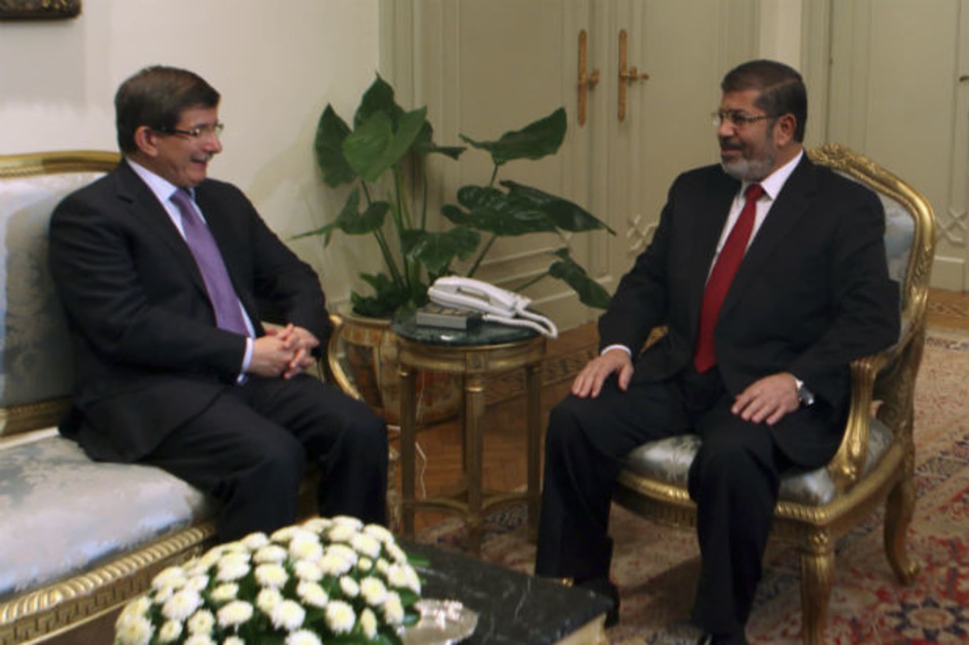 Egypt's President Mohamed Mursi attends a meeting with Turkish Foreign Minister Davotoglu at the presidential palace in Cairo