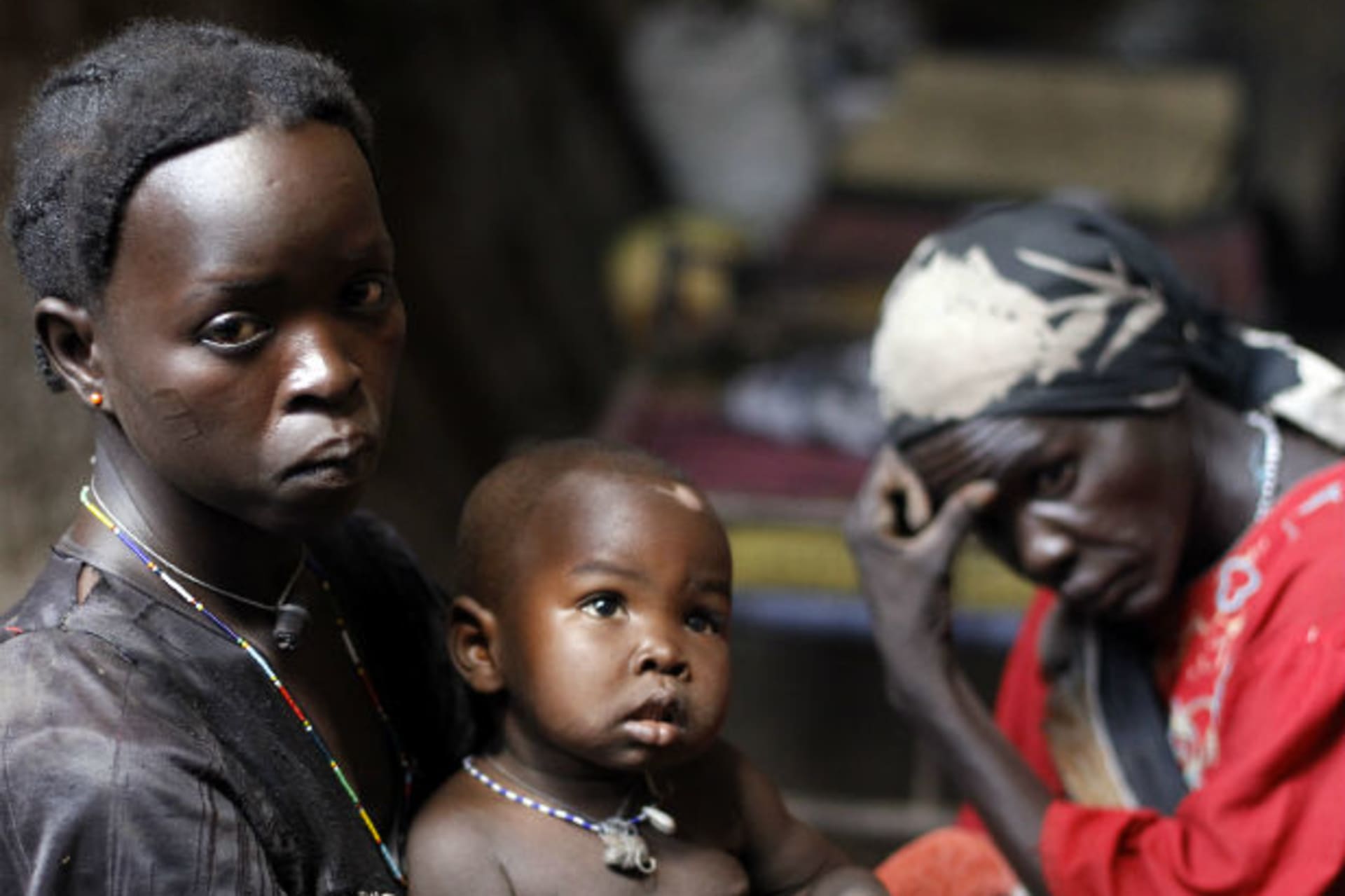 A woman holds her child in a cave in Bram village in the Nuba Mountains, South Kordofan, April 28, 2012.