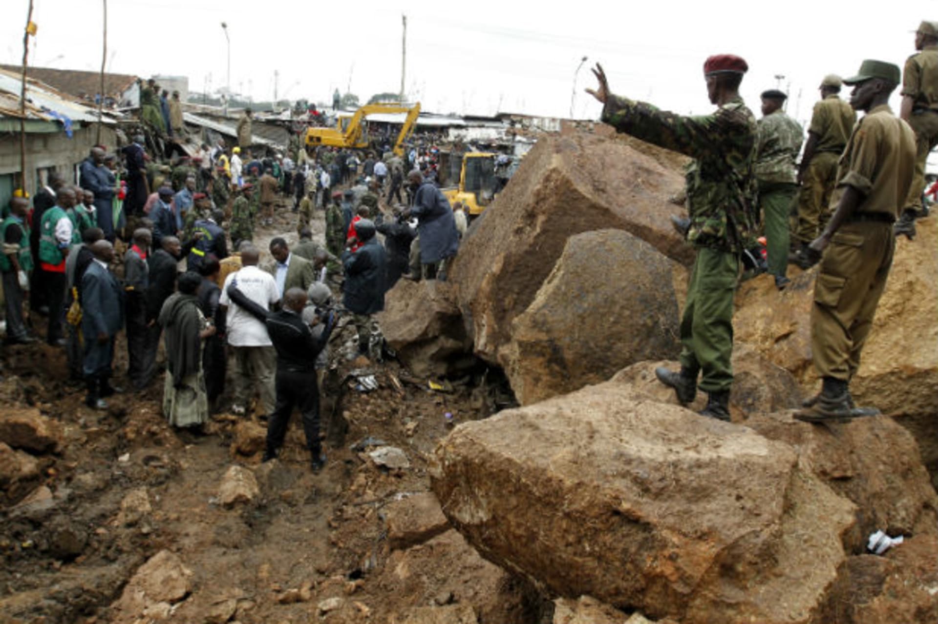 Policemen secure the scene of a landslide at the Mathare valley slum after boulders, rocks and mud tumbled down a hillside overlooking the slum, smashing into the houses and burying the occupants in Kenya's capital Nairobi, April 4, 2012.