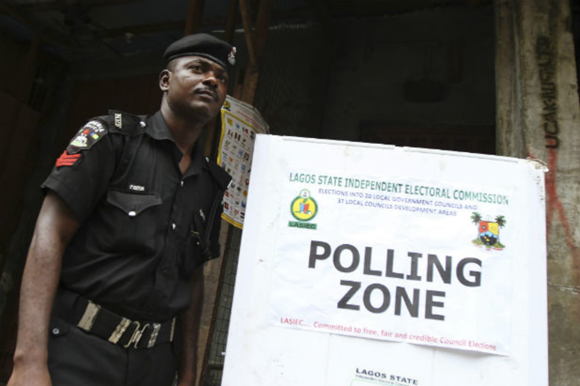 A policeman stands near a polling booth during the local government election in Nigeria's commercial capital Lagos October 22, 2011.