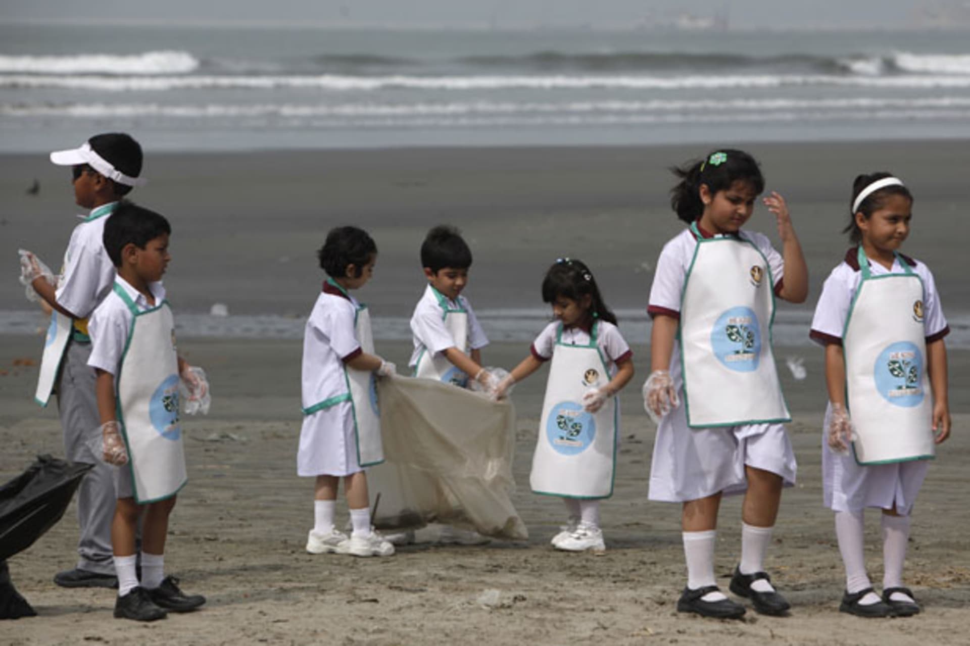 <p>Children in Karachi, Pakistan, clean up a beach for Earth Day 2013 (Akhtar Soomro/Courtesy Reuters).</p>