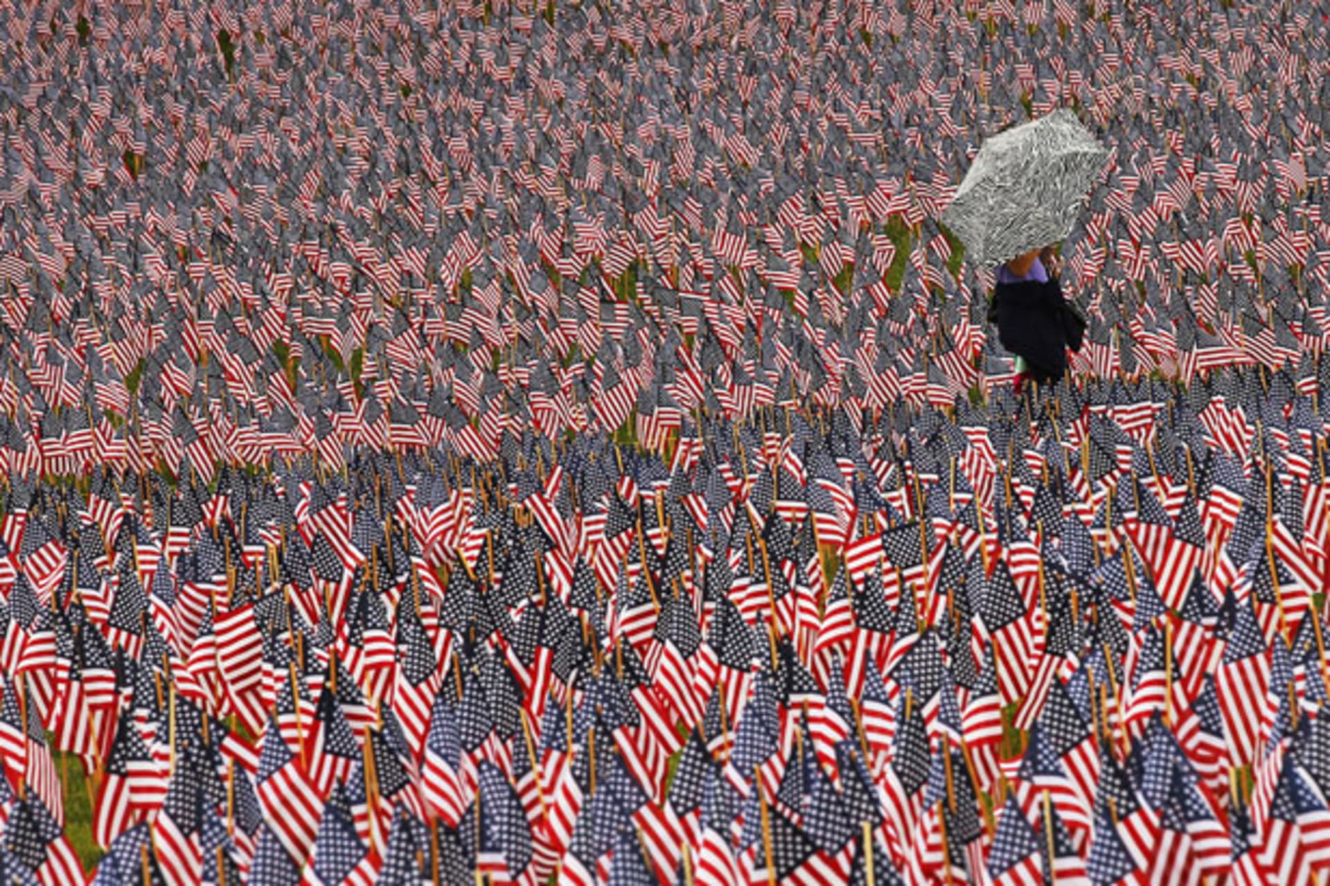 <p>A pedestrian walks through a Memorial Day display of American flags on the Boston Common (Brian Snyder/Courtesy Reuters).</p>
