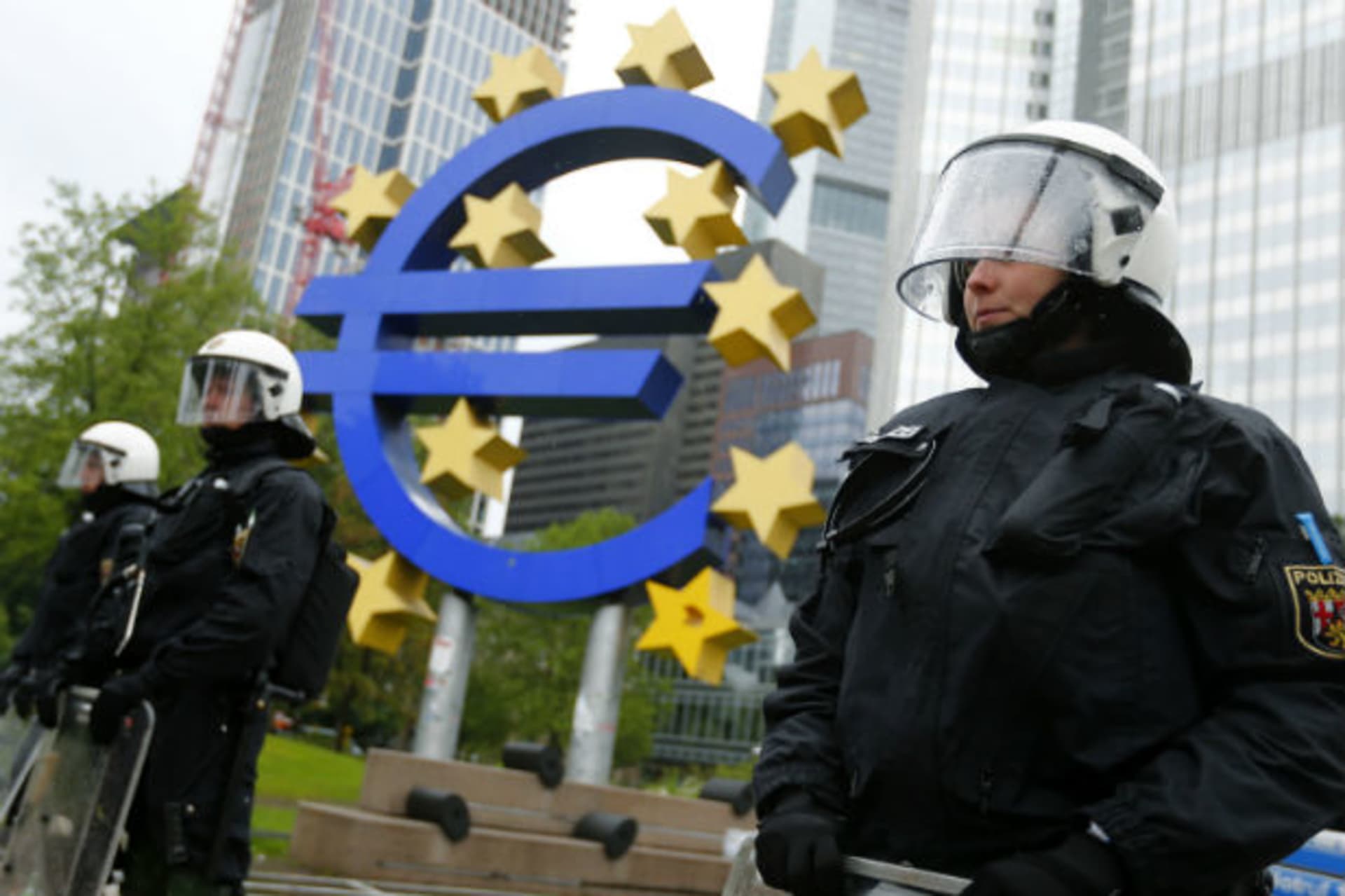 <p>Global financial recessions have created pressure on democratic systems. Riot police stand near the euro sign in front of the European Central Bank (ECB) headquarters during an anti-capitalist “Blockupy” demonstration on May 31, 2013.</p>
