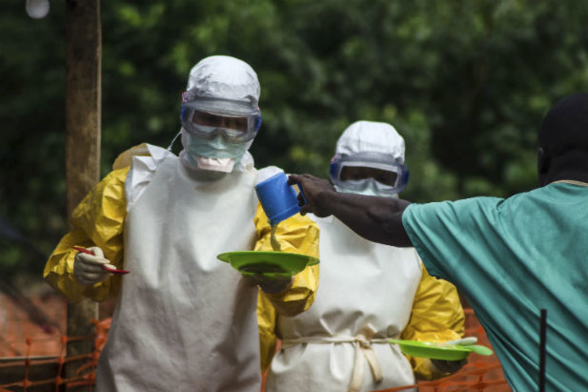 Medical staff working with Medecins sans Frontieres (MSF) prepare to bring food to patients kept in an isolation area at the MSF Ebola treatment center in Kailahun, Sierra Leone, July 20, 2014 (Tommy Trenchard/Courtesy Reuters).