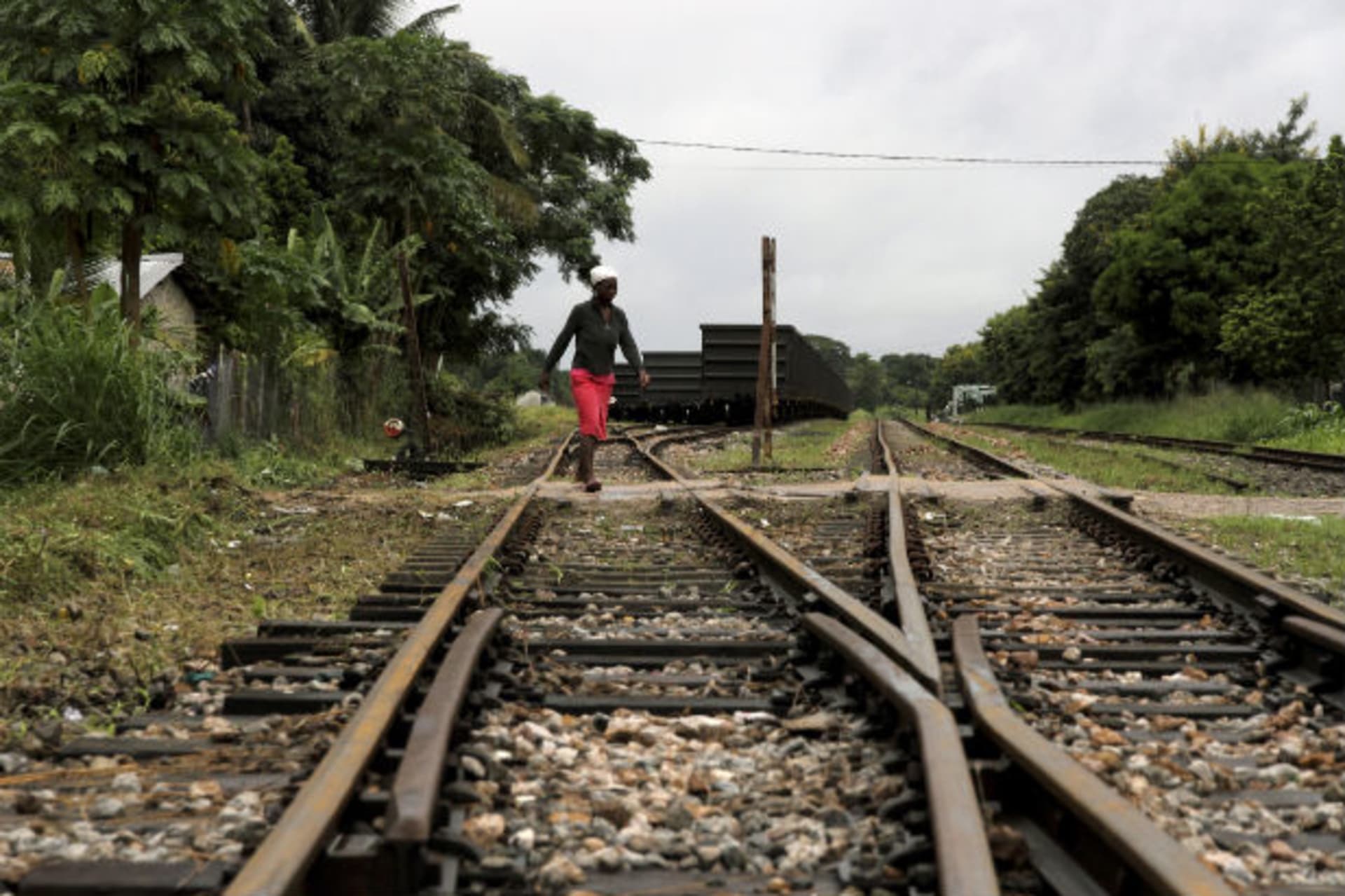 A woman crosses a railway line at Dondo, about 20km (12.4 miles) from Beira port, February 14, 2013.