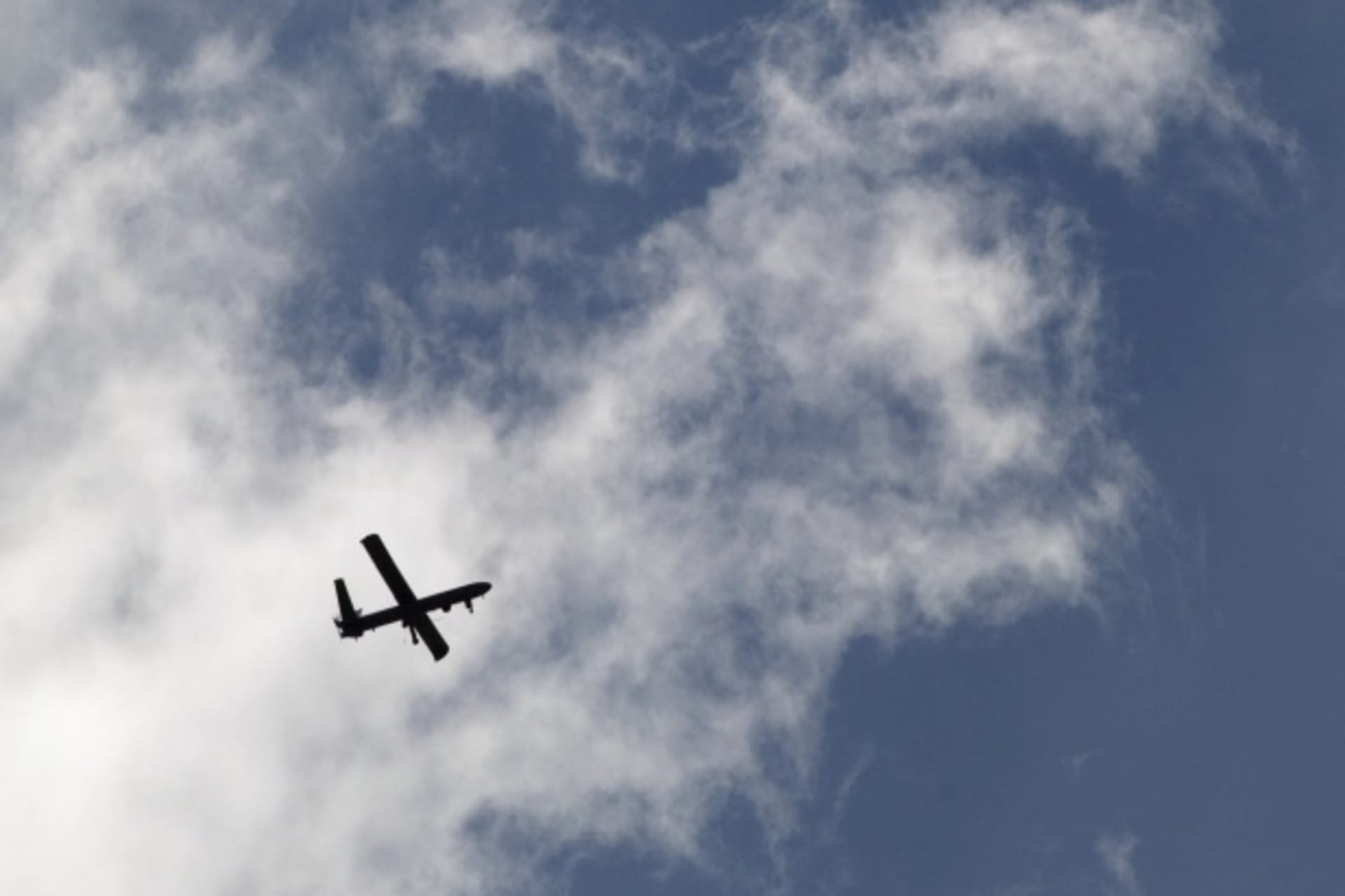 <p>A drone circles the skies (Courtesy Reuters/Andy Clark).</p>
