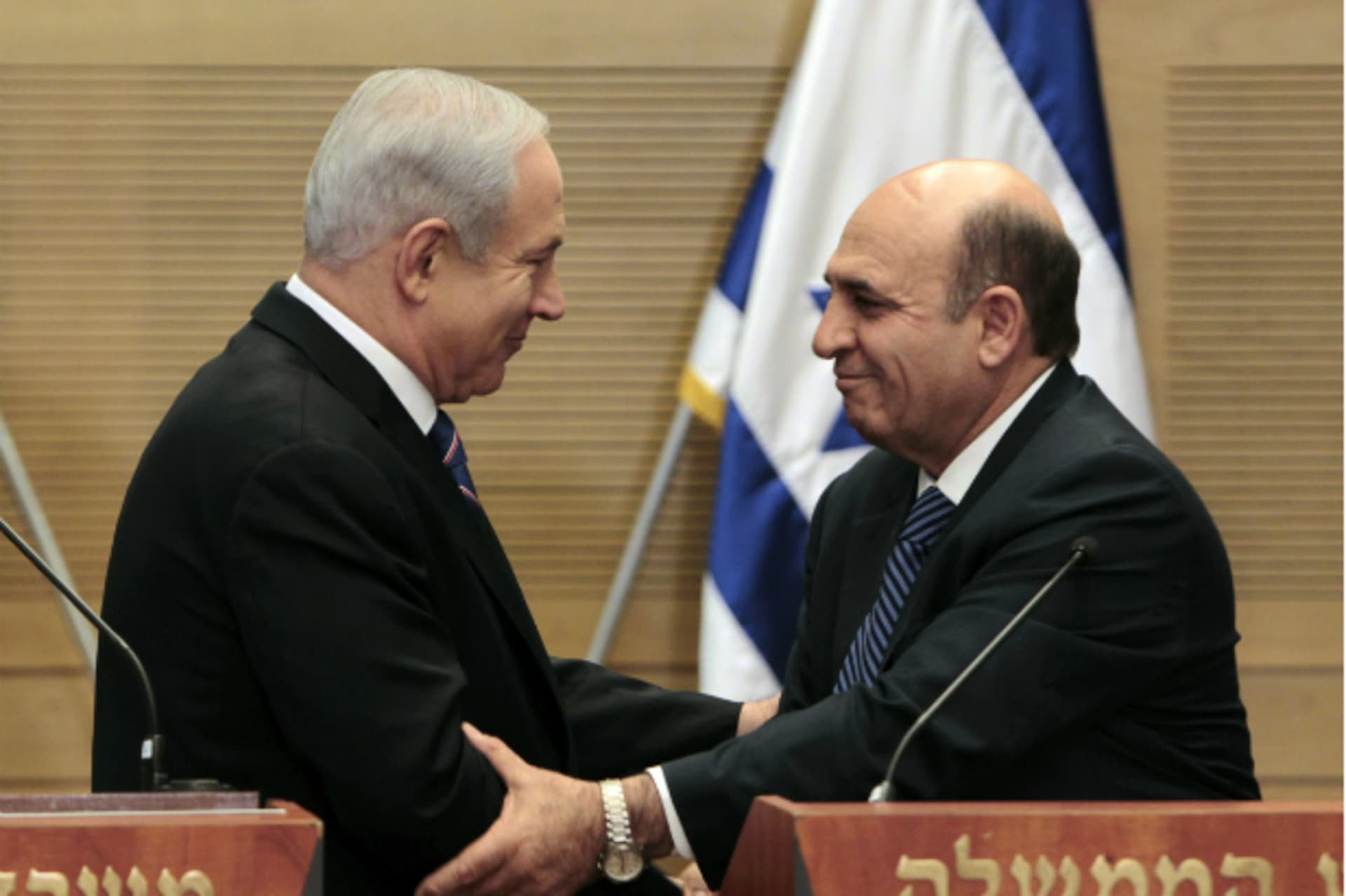 <p>Israeli prime minister Netanyahu and the new Kadima party head, Shaul Mofaz, shake hands (Ammar Awad/Courtesy Reuters).</p>
