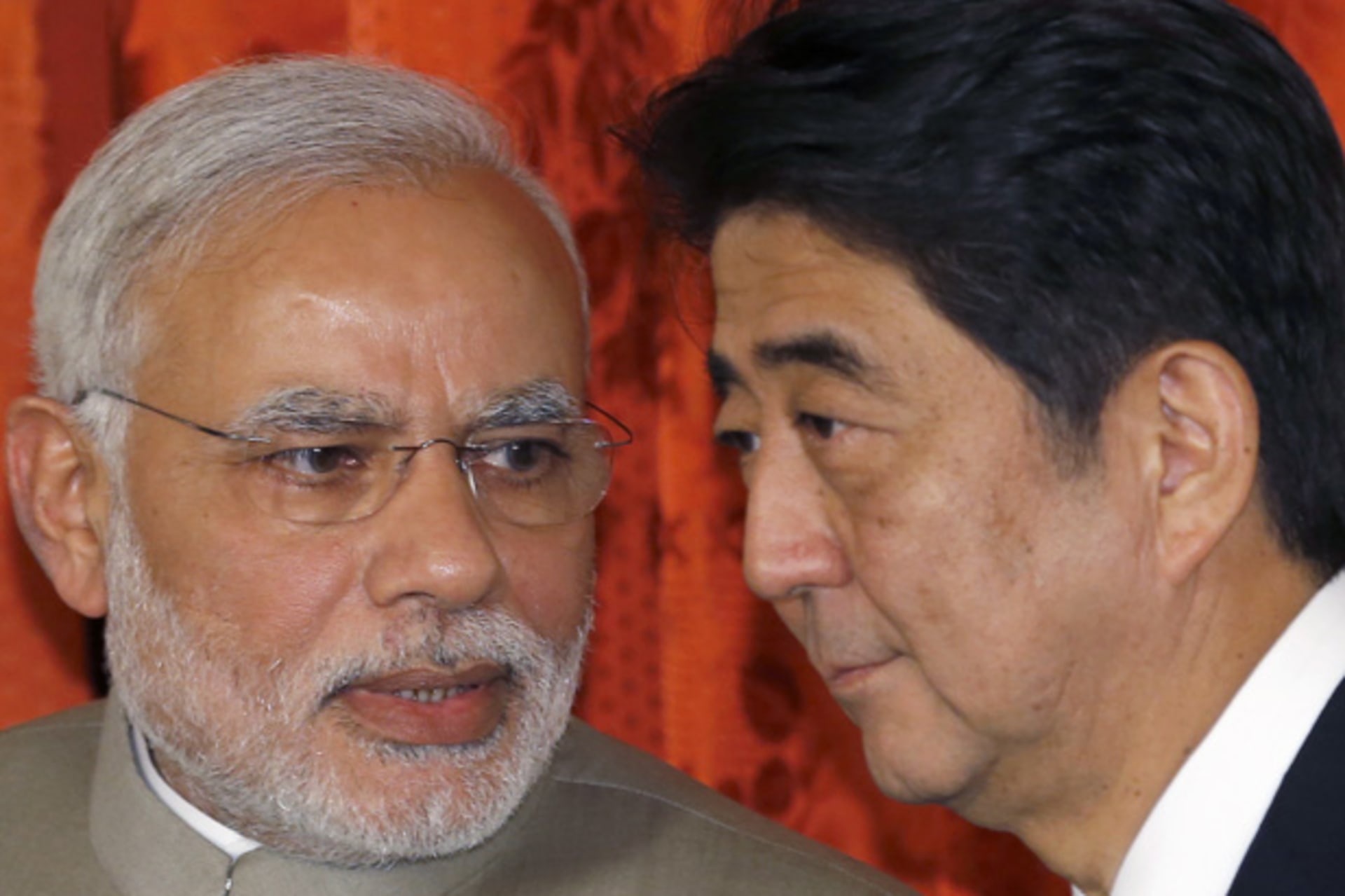 India's PM Narendra Modi talks with Japan's PM Shinzo Abe during a signing ceremony at the state guest house in Tokyo