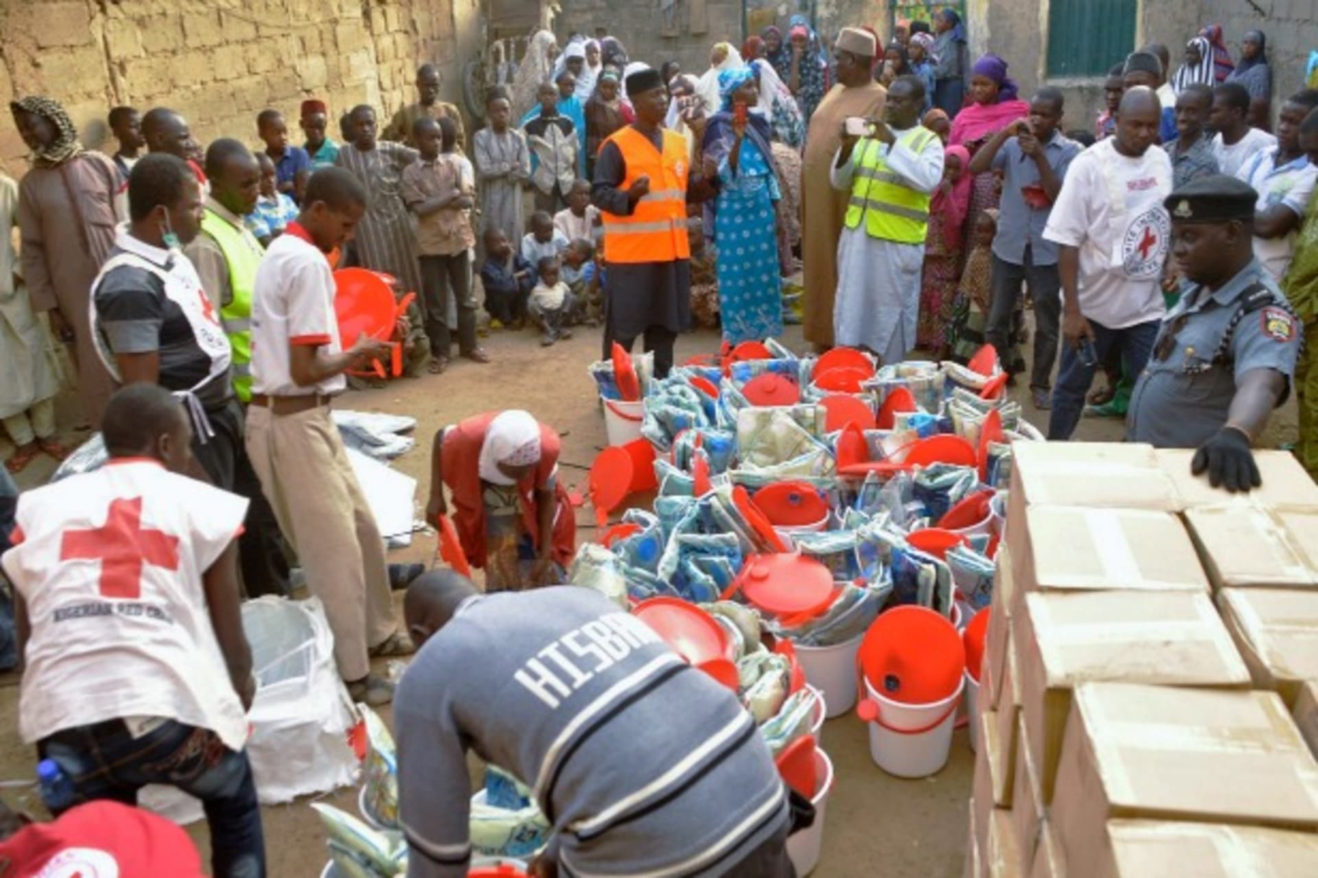 <p>Displaced people gather as the Red Cross in Kano distributes relief materials to displaced victims of the Boko Haram violence, December 16, 2014. (Courtesy Reuters/Stringer)</p>

