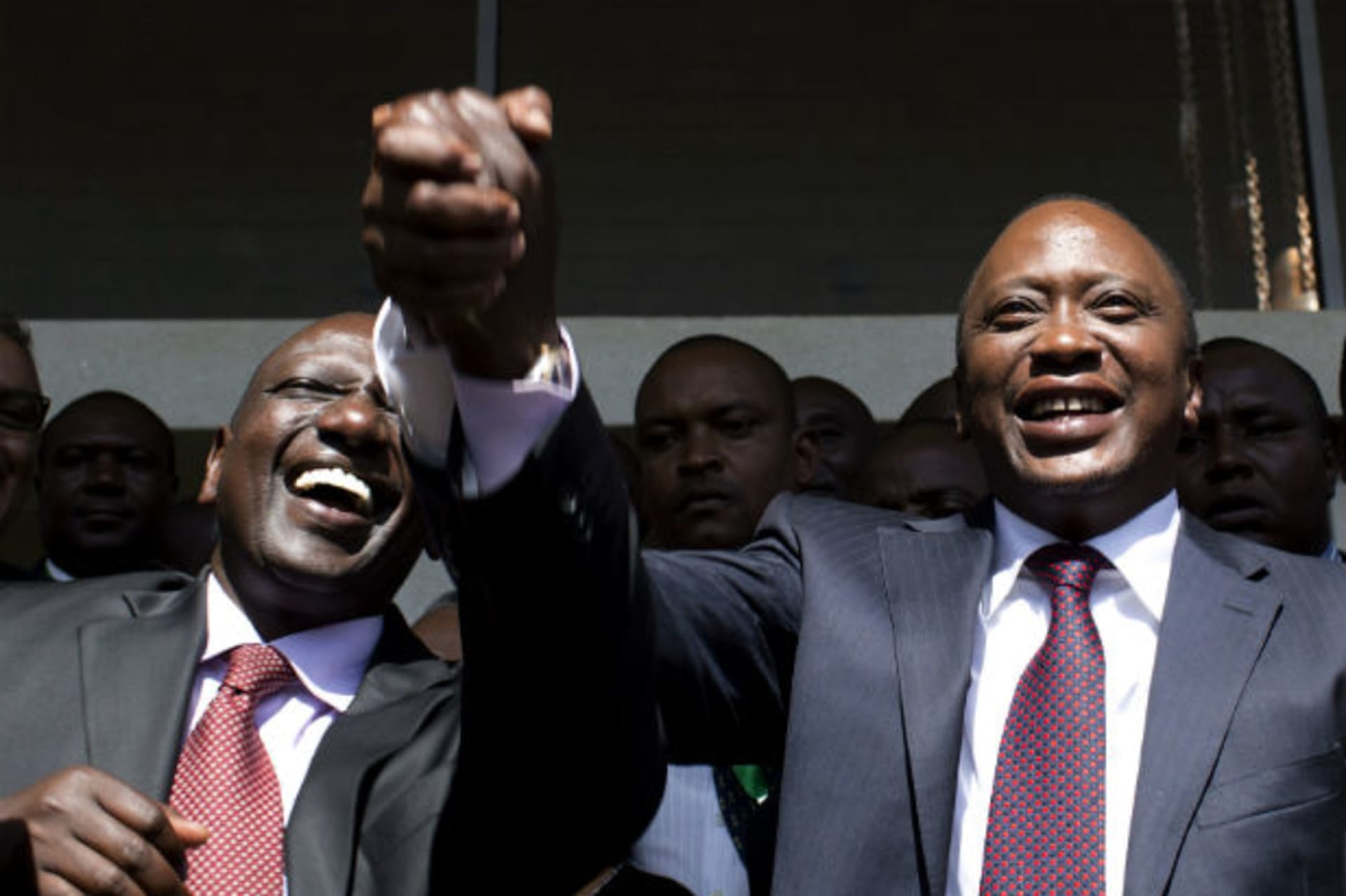President-elect Uhuru Kenyatta (R) greets his supporters with his running mate, former cabinet minister William Ruto after attending a news conference in Nairobi March 9, 2013.