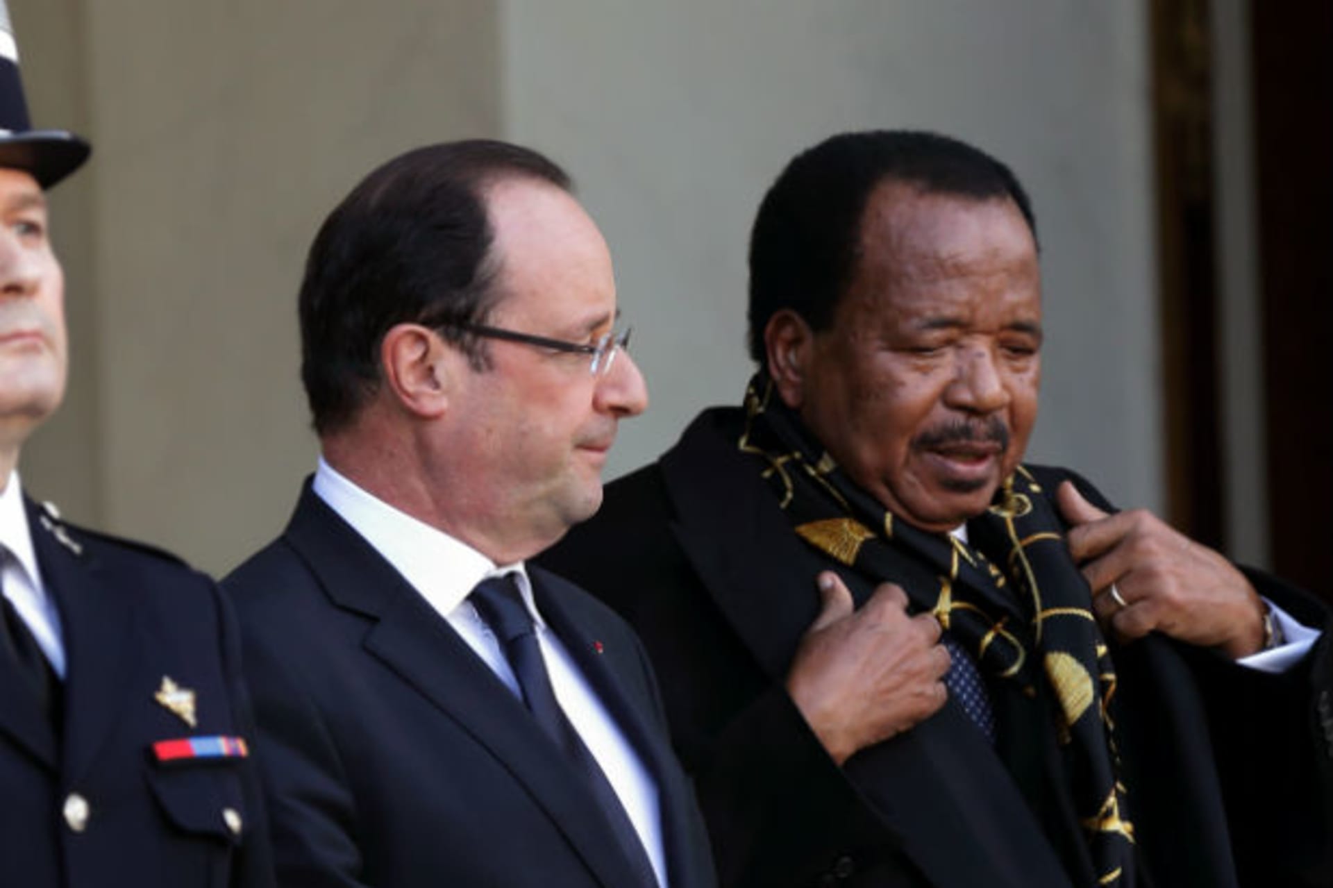 French President Francois Hollande (C) speaks with Cameroon's President Paul Biya (R) after a meeting at the Elysee Palace in Paris, January 30, 2013.