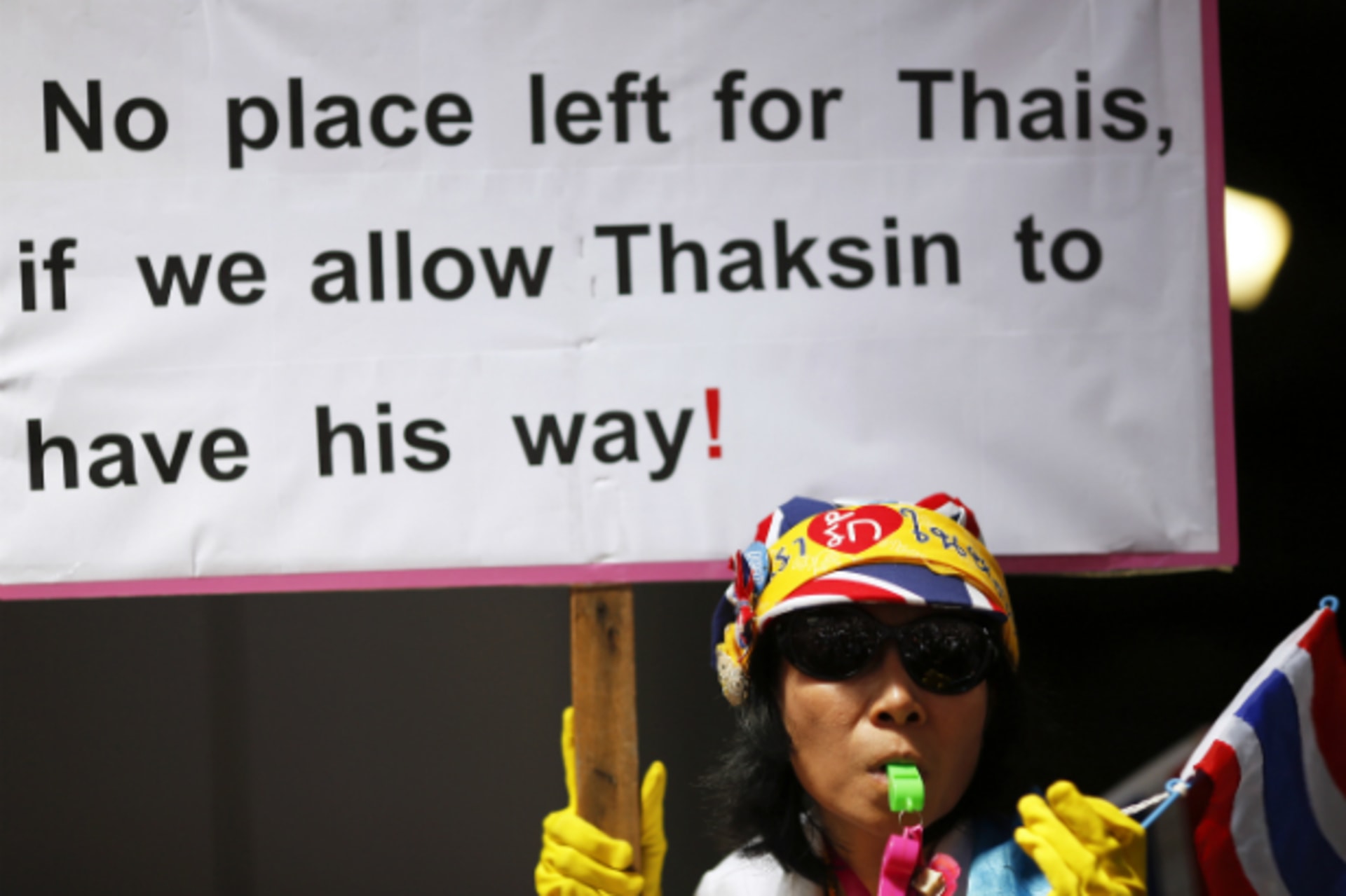 <p>A protester holds a banner as thousands gather against the amnesty bill in Bangkok’s central business district on November 6, … Speaker said on Wednesday, a move that could defuse rising tension on the streets of Bangkok. (Damir Sagolj/Courtesy Reuters)</p>
