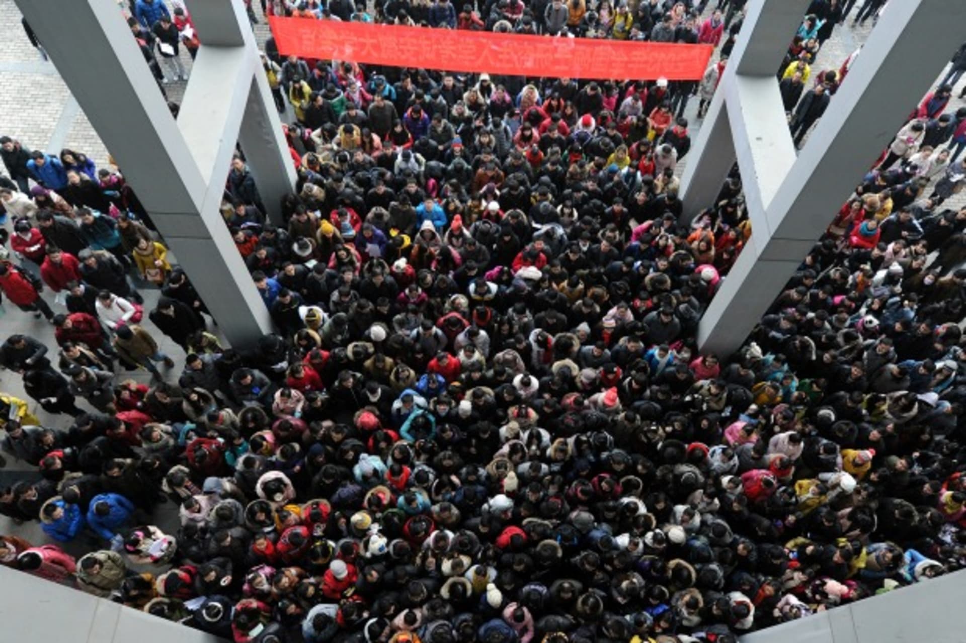 <p>Examinees walk into the entrance of a classroom building to take part in a three-day entrance exam for postgraduate studies, at Anhui University, in Hefei, Anhui province on January 5, 2013 (Stringer/Courtesy Reuters).</p>

