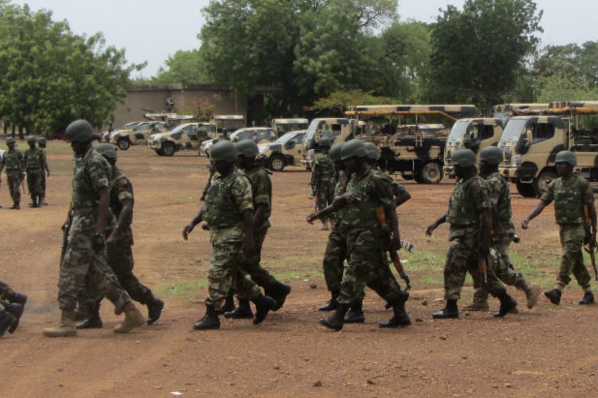 Soldiers from Lagos, part of an expected 1,000 reinforcements sent to Adamawa state to fight Boko Haram Islamists, walk near trucks as they arrive with the 23rd Armoured Brigade in Yola May 20, 2013.