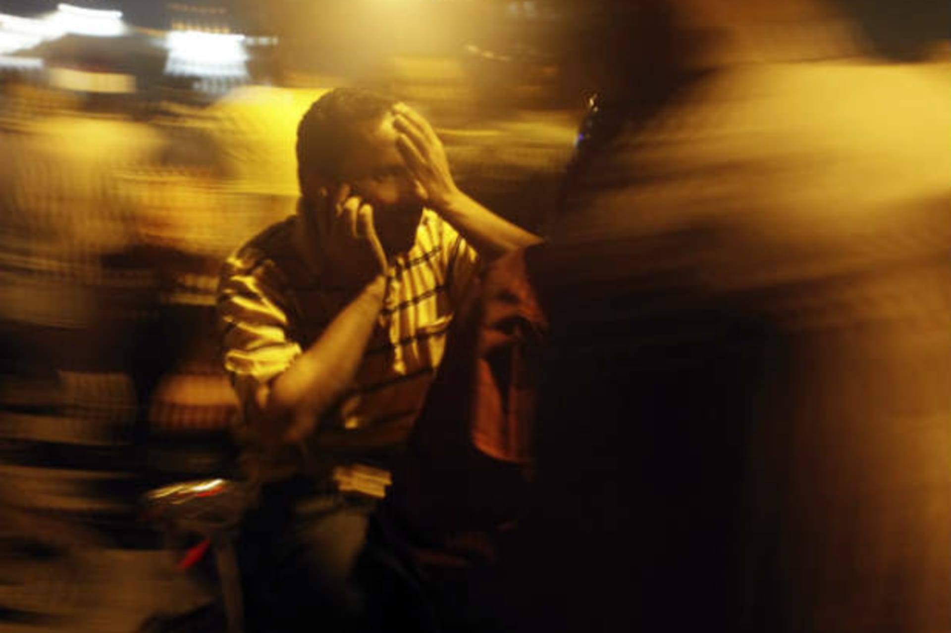 Supporters of deposed Egyptian President Mohamed Mursi carry a man who was wounded by rubber bullets and affected by tear gas during clashes with riot police on the Sixth of October Bridge over the Ramsis square area in central Cairo July 15, 2
